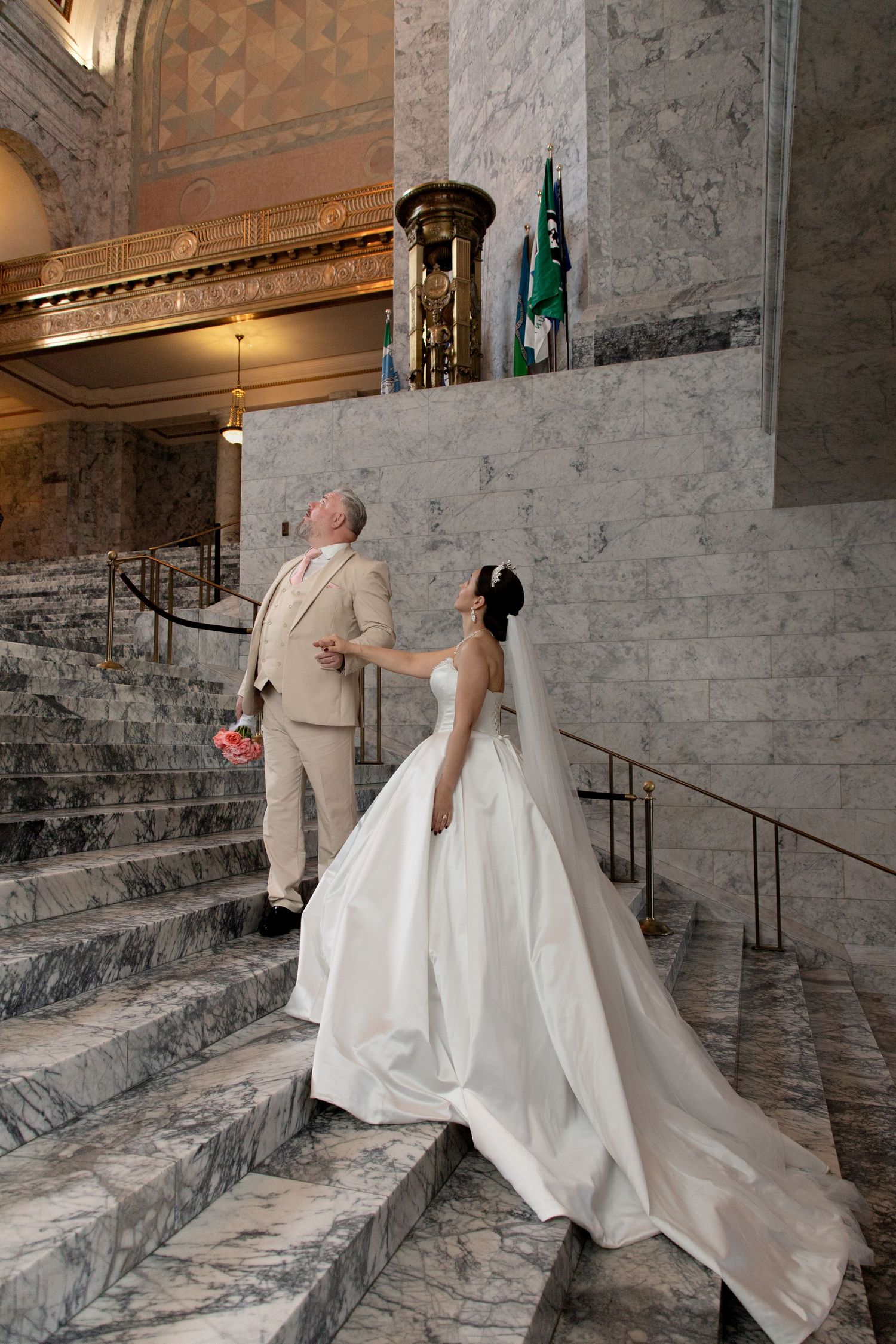 Bride and groom walking through the marble halls of the Washington State Capitol during an intimate Olympia wedding session