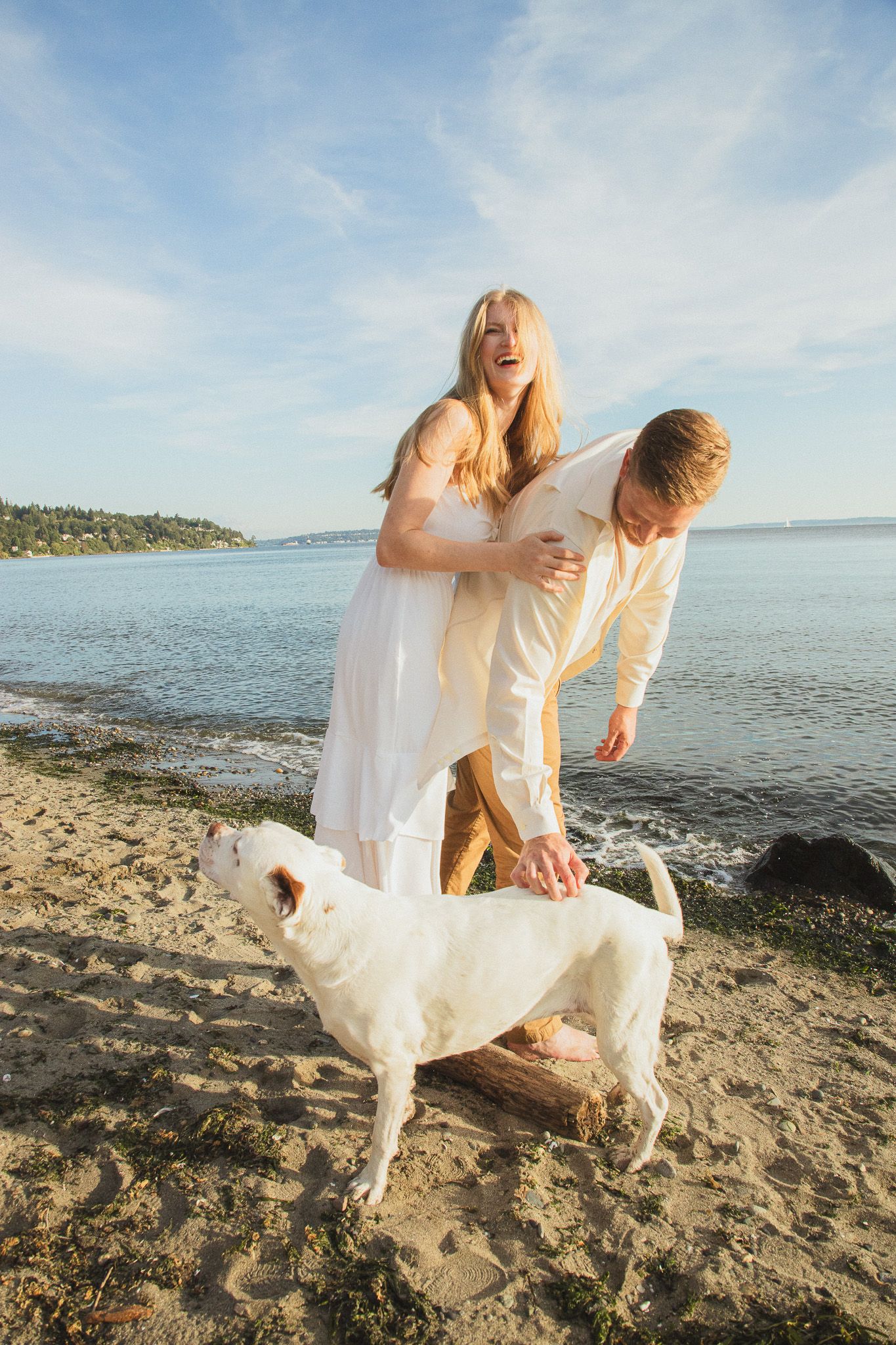 Seattle couples photographer capturing a golden hour couple photoshoot at Discovery Park with Puget Sound views in the background