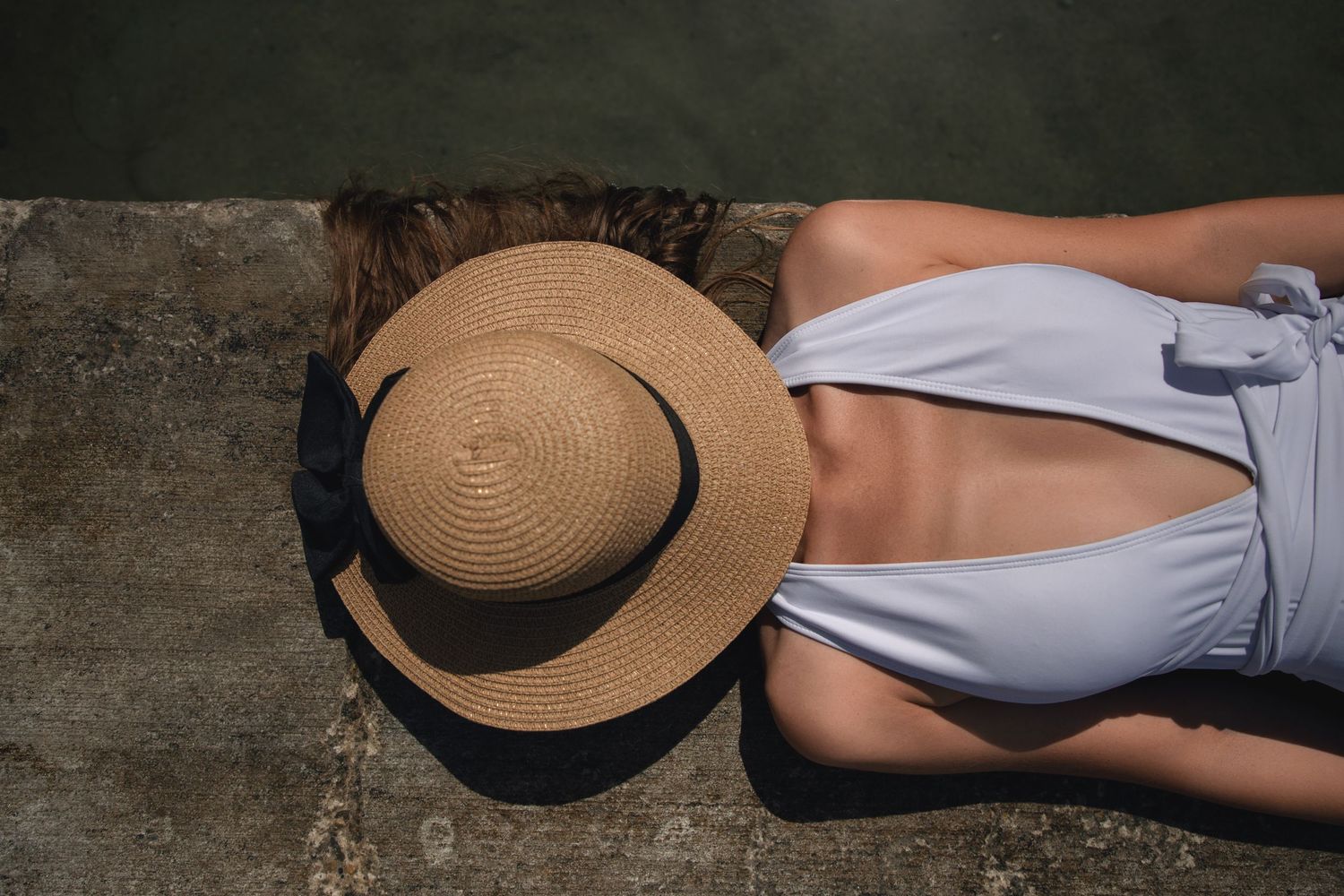 California portrait photographer capturing a woman’s portrait photoshoot by a swimming pool