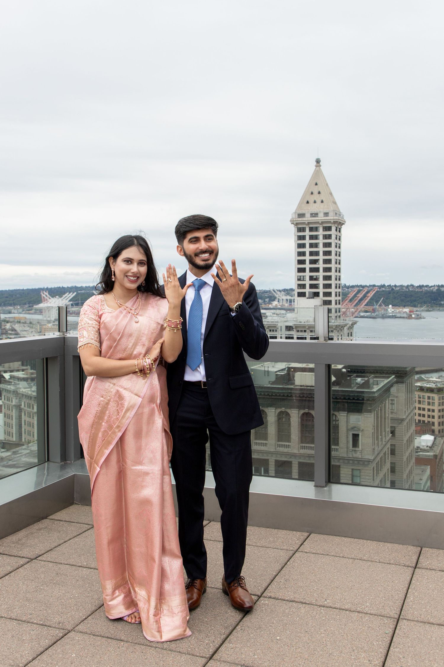 Newlywed couple showing their wedding rings on the Seattle Municipal Court rooftop