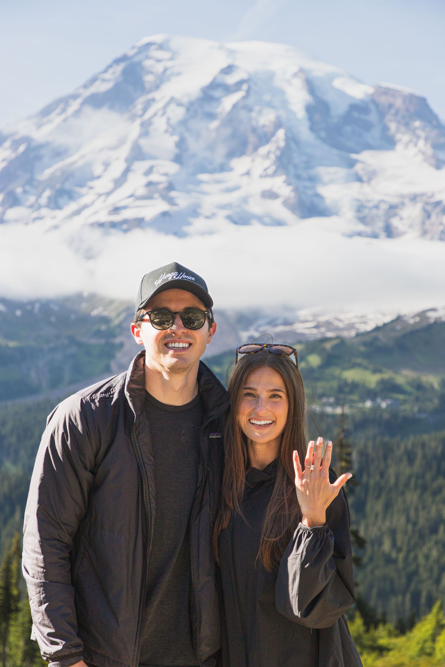 Newly engaged couple showing the engagement ring with Mount Rainier in the background
