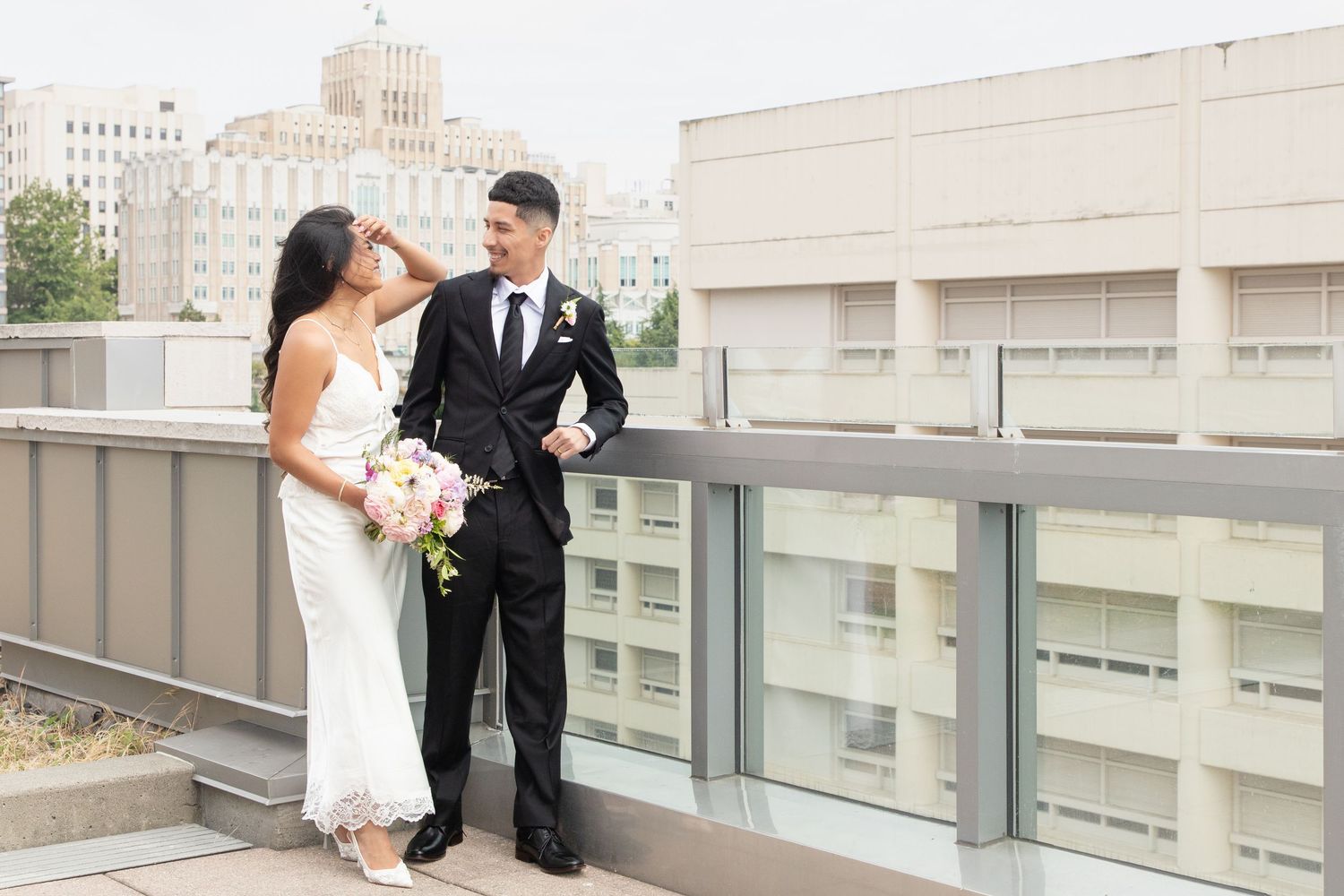 Newlyweds sharing a quiet moment on the rooftop after their Seattle courthouse wedding