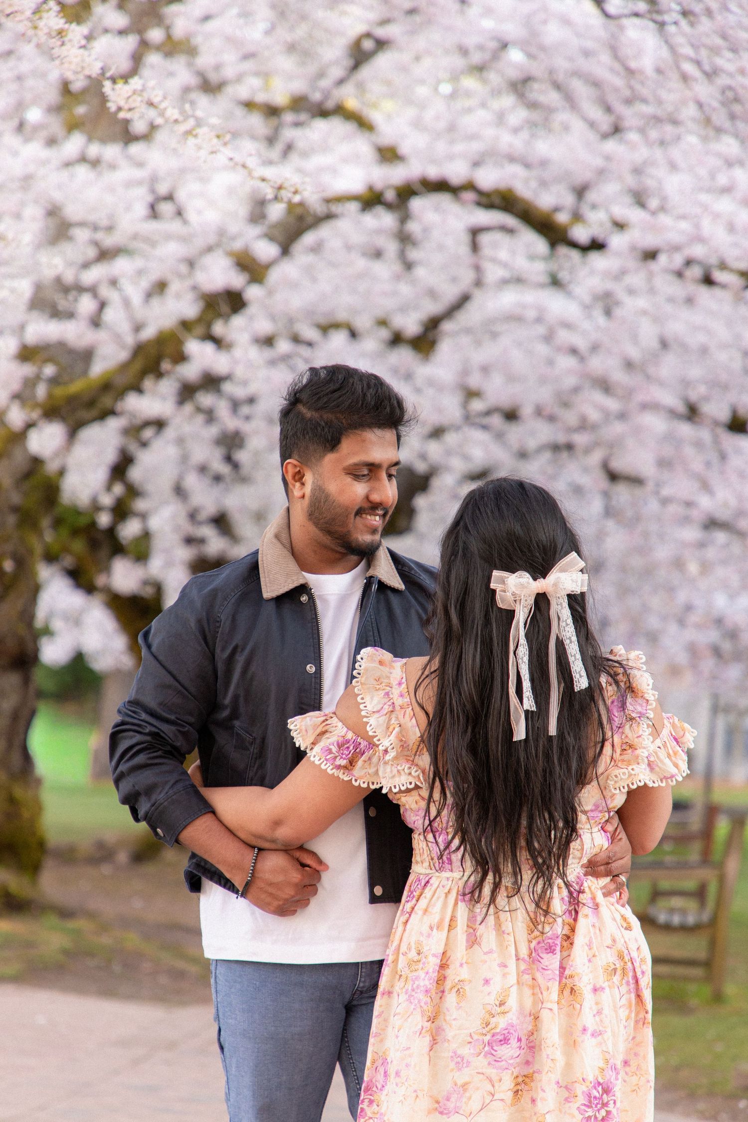 Couple photoshoot under cherry blossoms at the University of Washington, Seattle spring engagement session