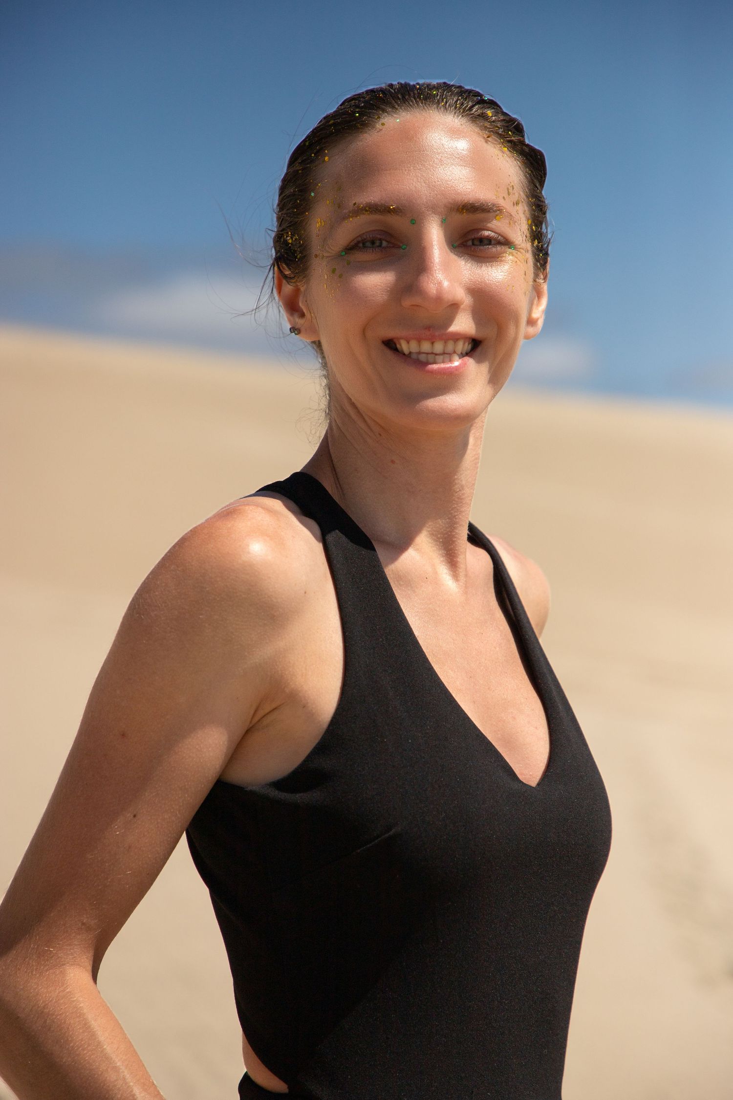 Creative close‑up portrait of a Seattle photographer during a creative portrait session at the Oregon sand dunes