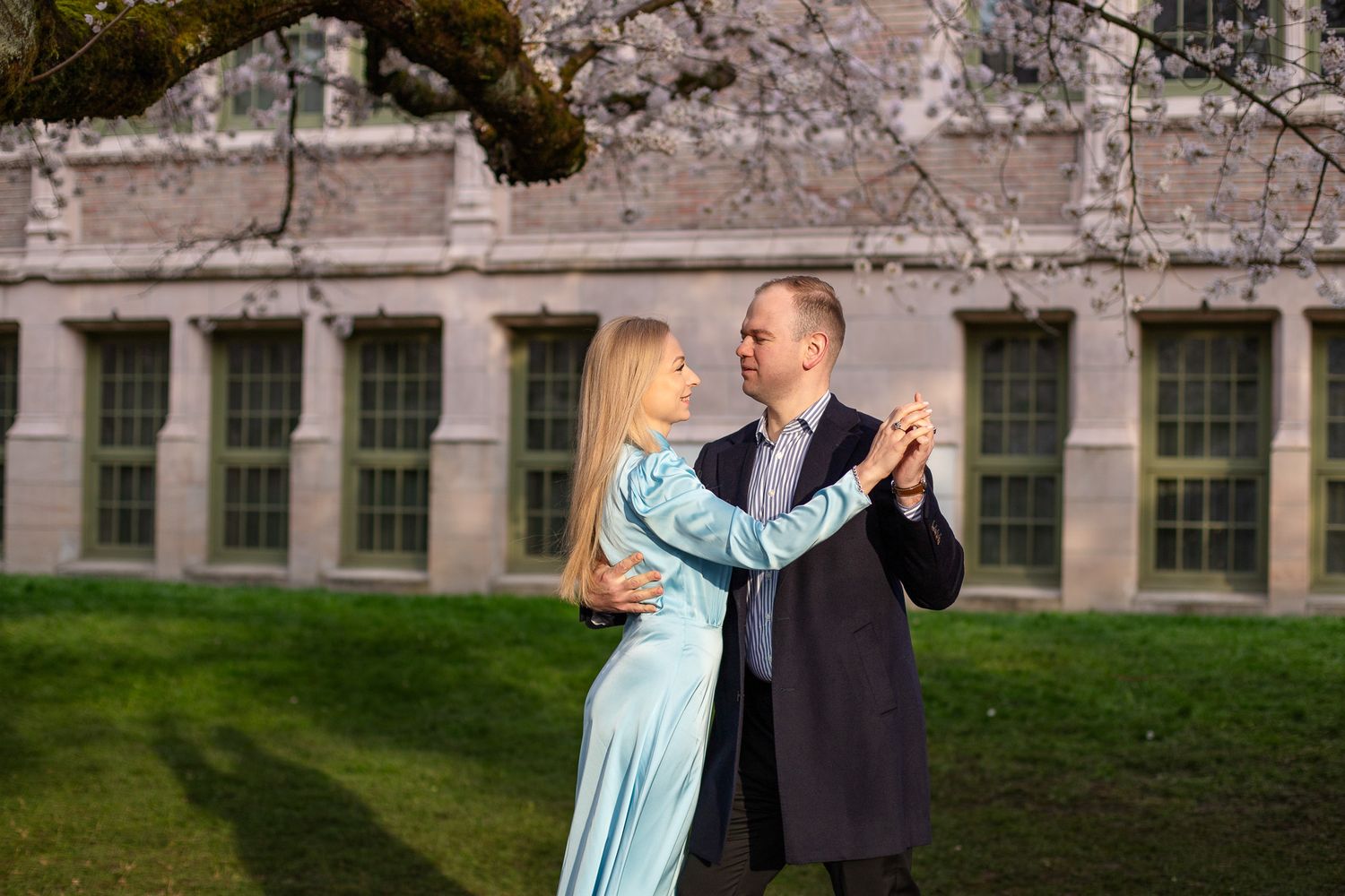 Seattle couple photographer capturing a couple under cherry blossoms during spring in Seattle