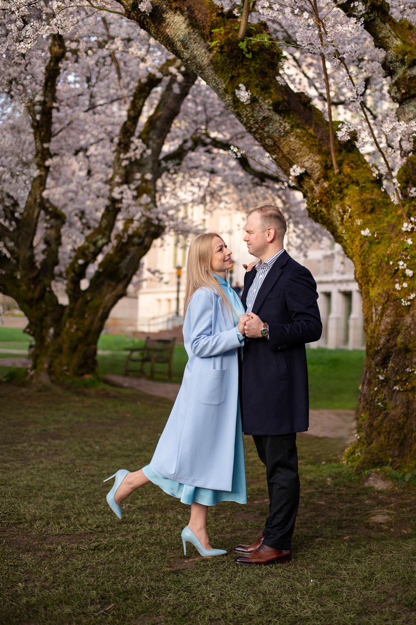 Romantic cherry blossom session at the University of Washington, Seattle couple walking together on campus