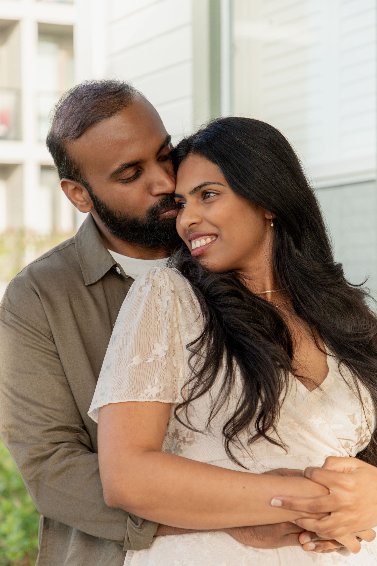 Romantic close-up of an engaged couple embracing during their Mukilteo Lighthouse photoshoot