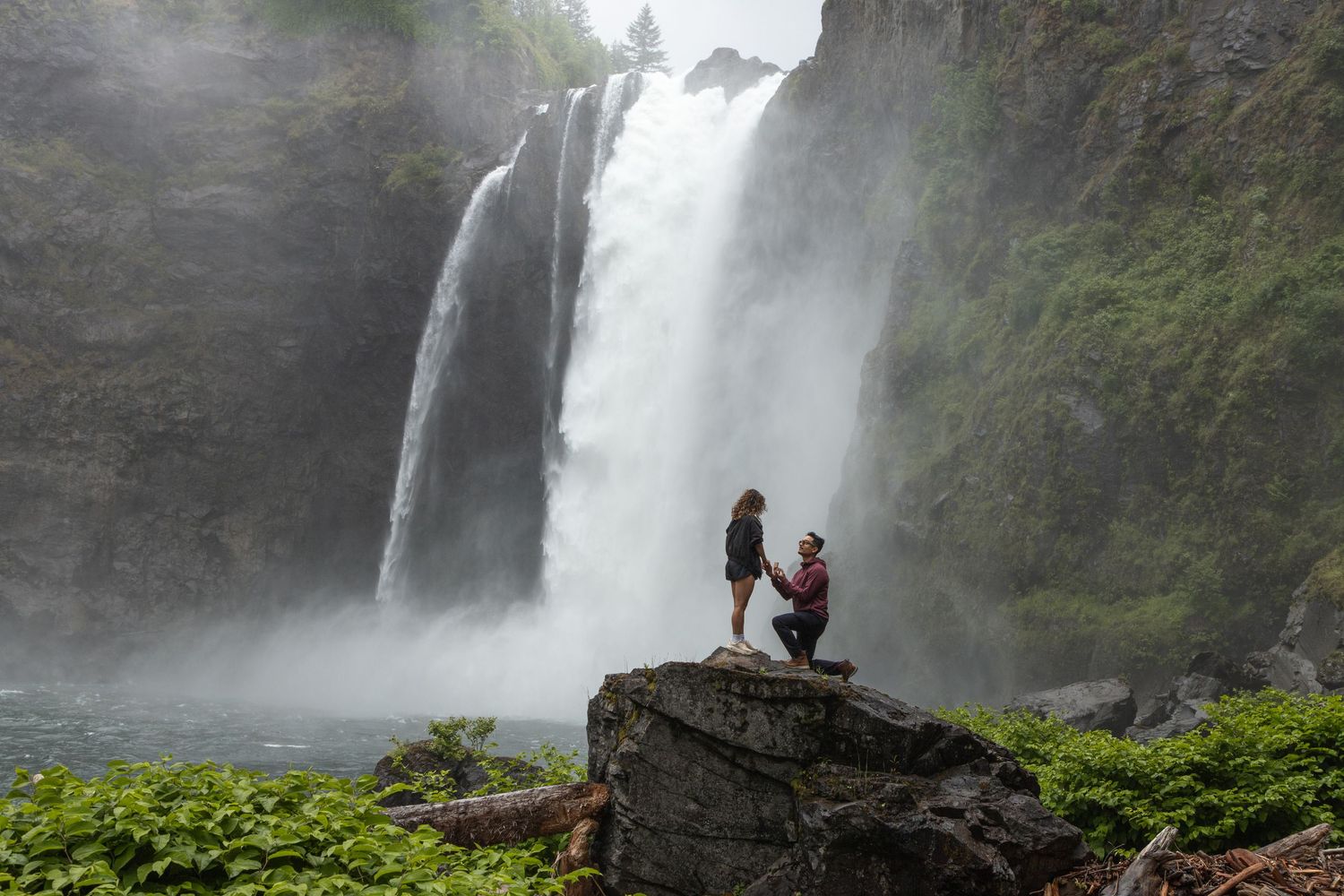 Surprise marriage proposal on a rock in front of Snoqualmie Falls in Washington