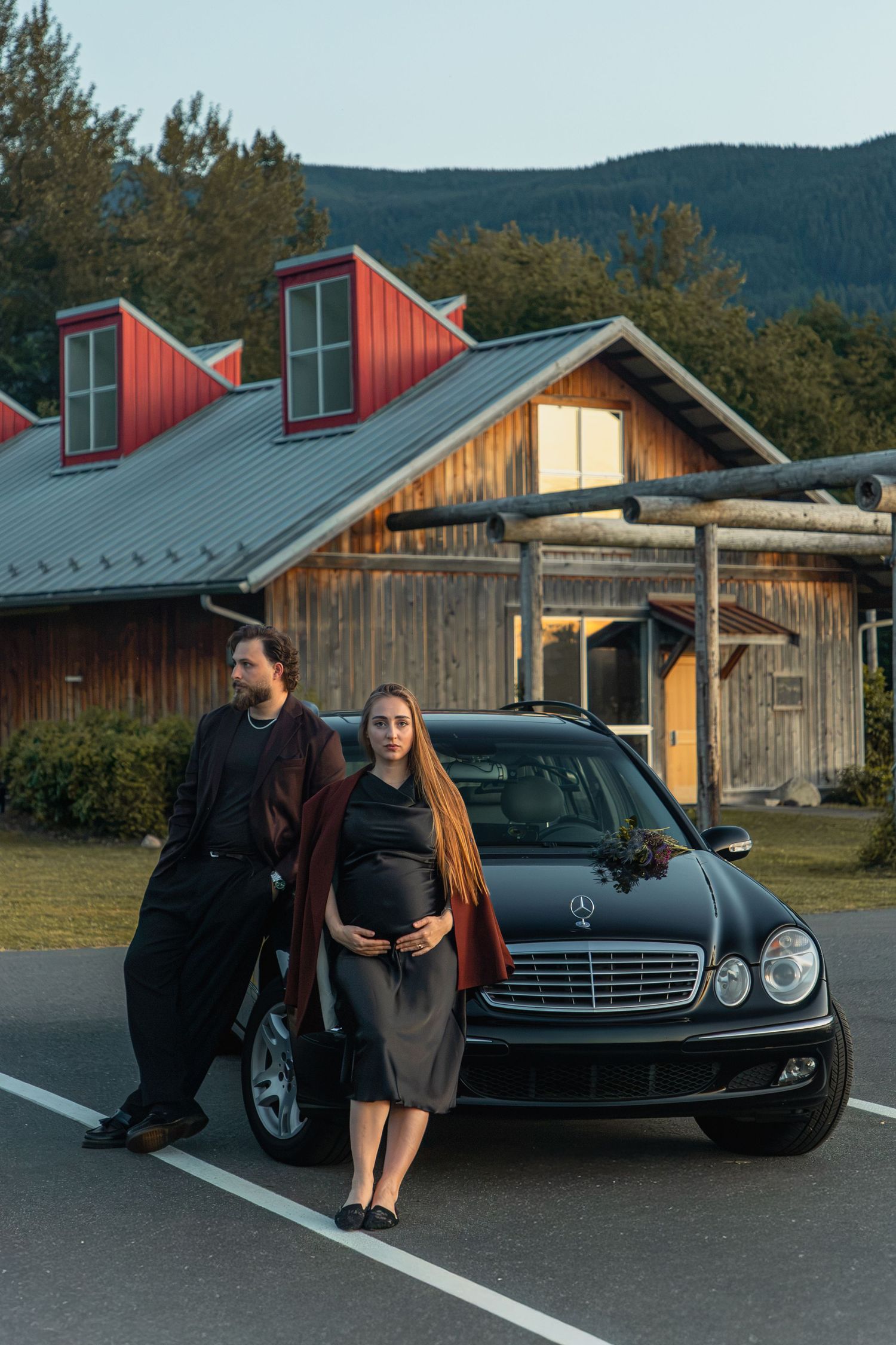 Expectant couple posing beside a classic Mercedes during a North Bend maternity photoshoot near Mount Si