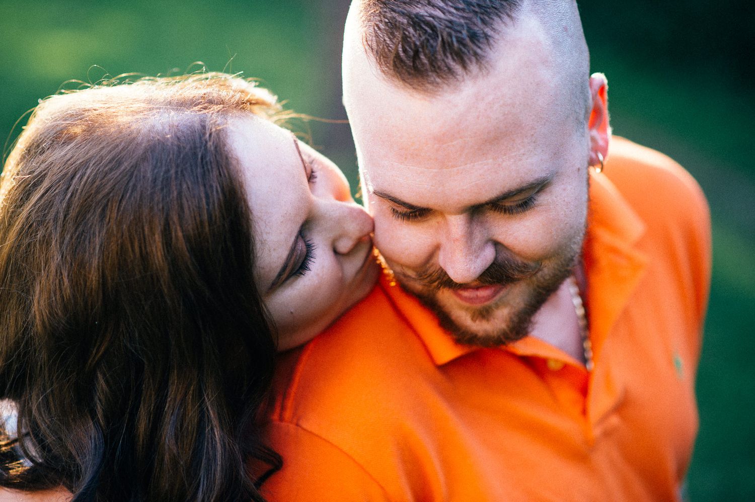 Intimate close-up moments between couple with one wearing bright orange.