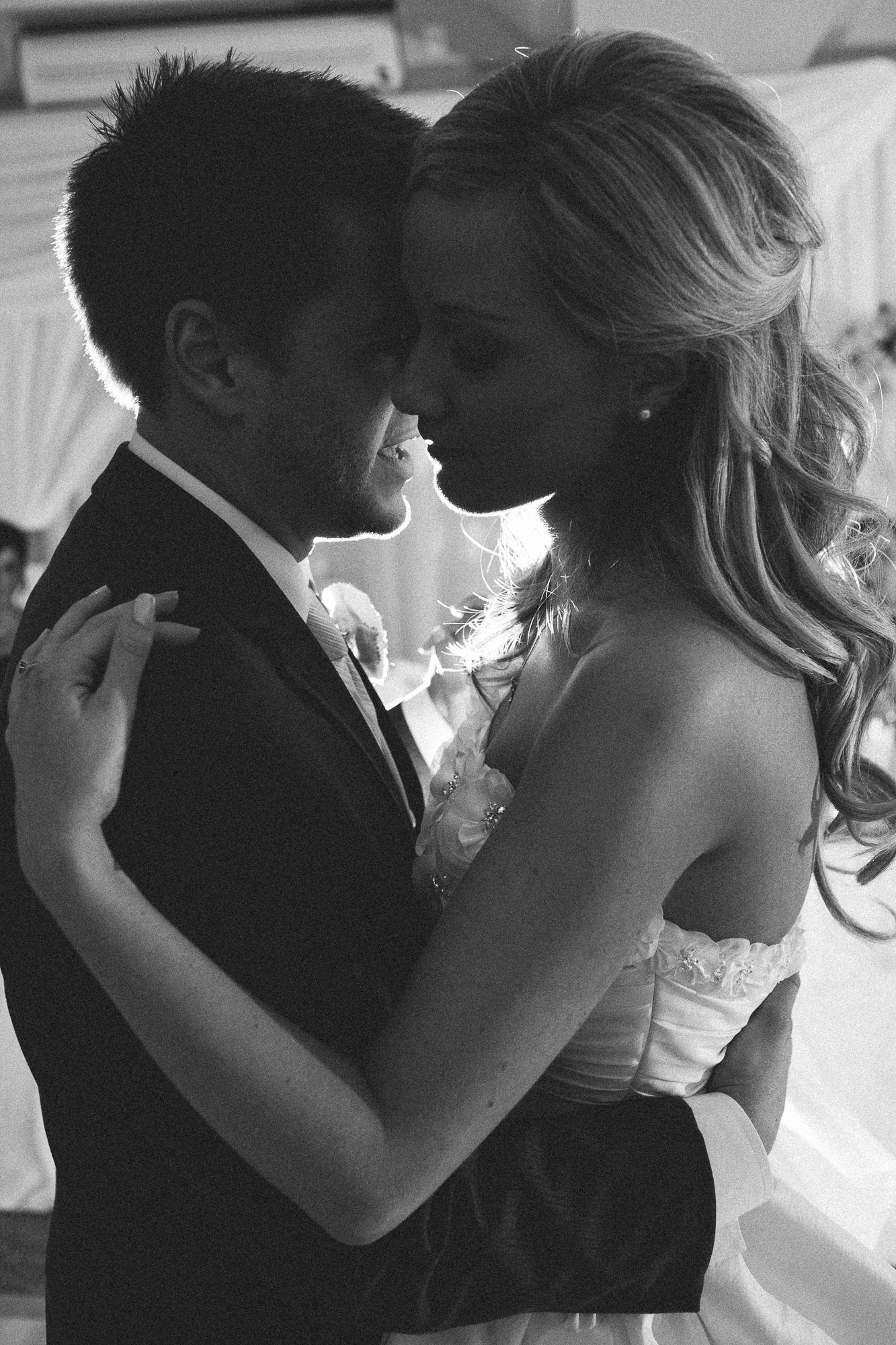 Romantic black and white series of a couple's intimate wedding dance moments.