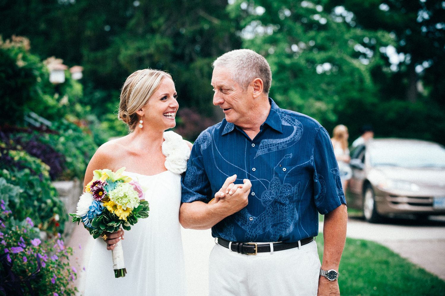 Candid outdoor wedding moments captured in garden setting with natural greenery.