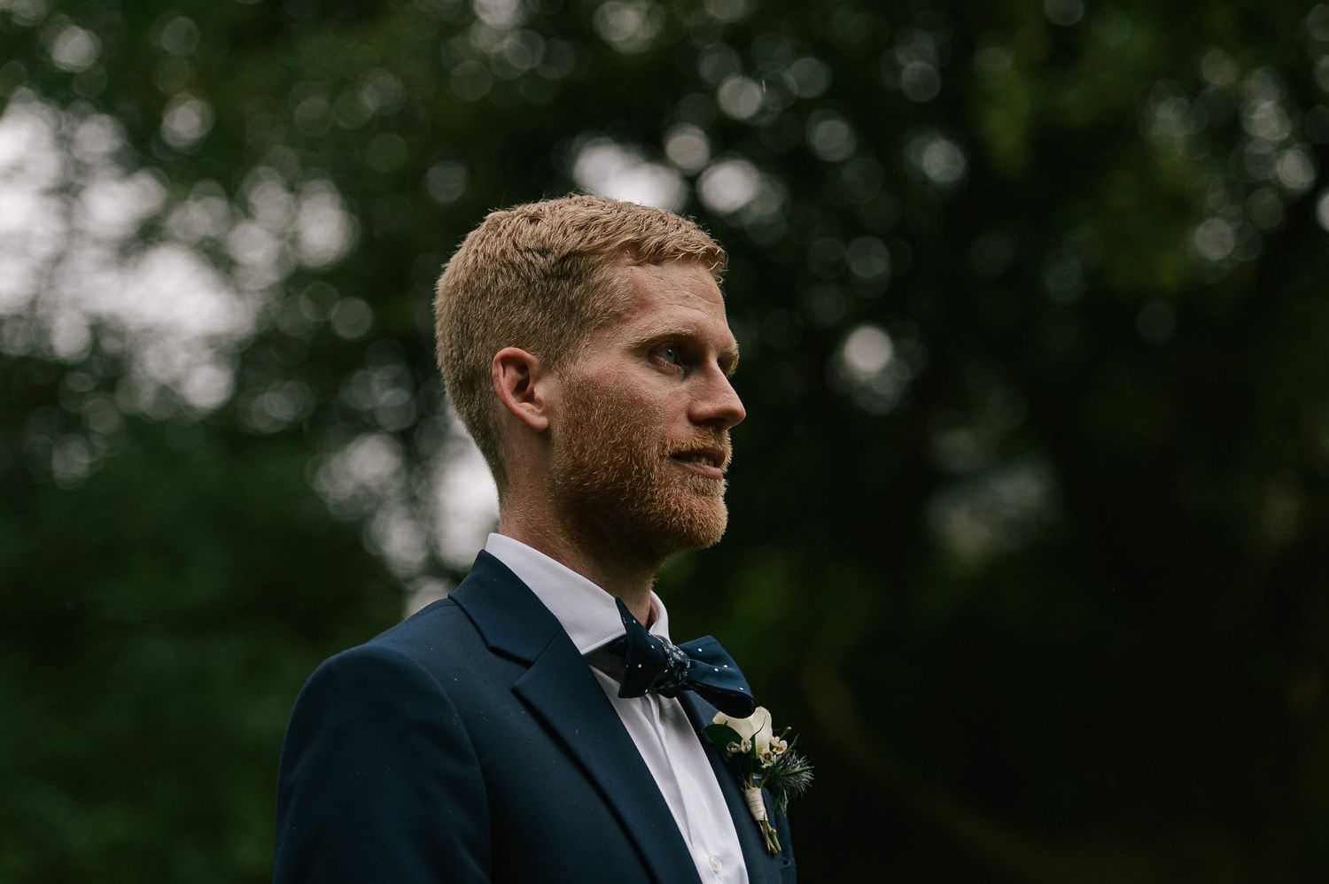 A romantic outdoor wedding moment captured in natural lighting with bokeh effects.