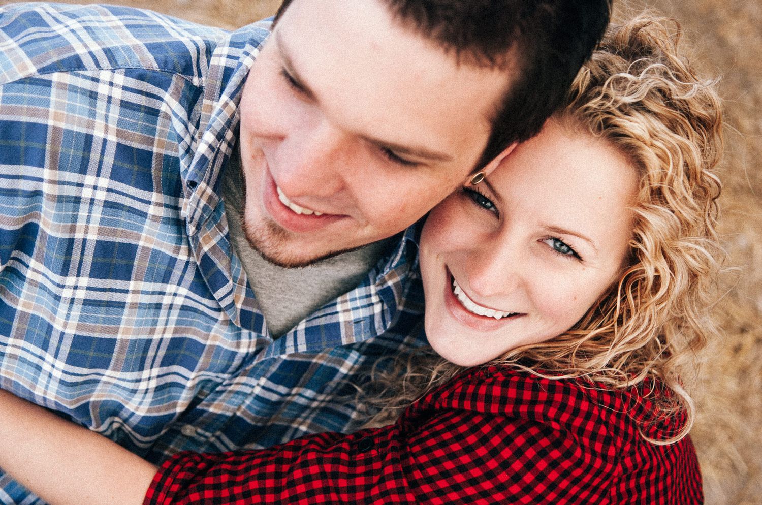 Close-up shots of couple in plaid and red clothing against hay bale backdrop.