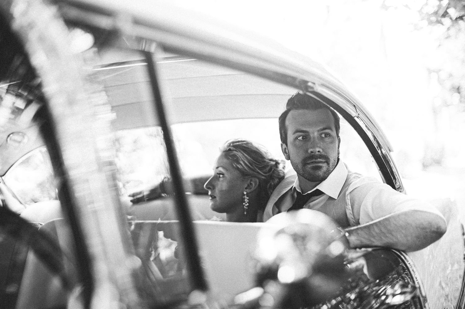 Black and white candid moments of a couple laughing and embracing during their wedding day.