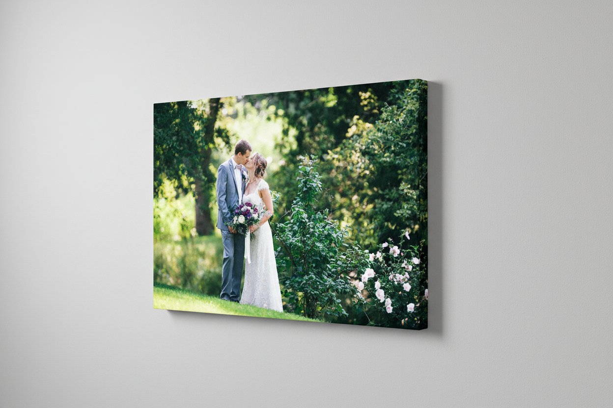 Canvas photo prints displayed on white wall showing outdoor portraits.