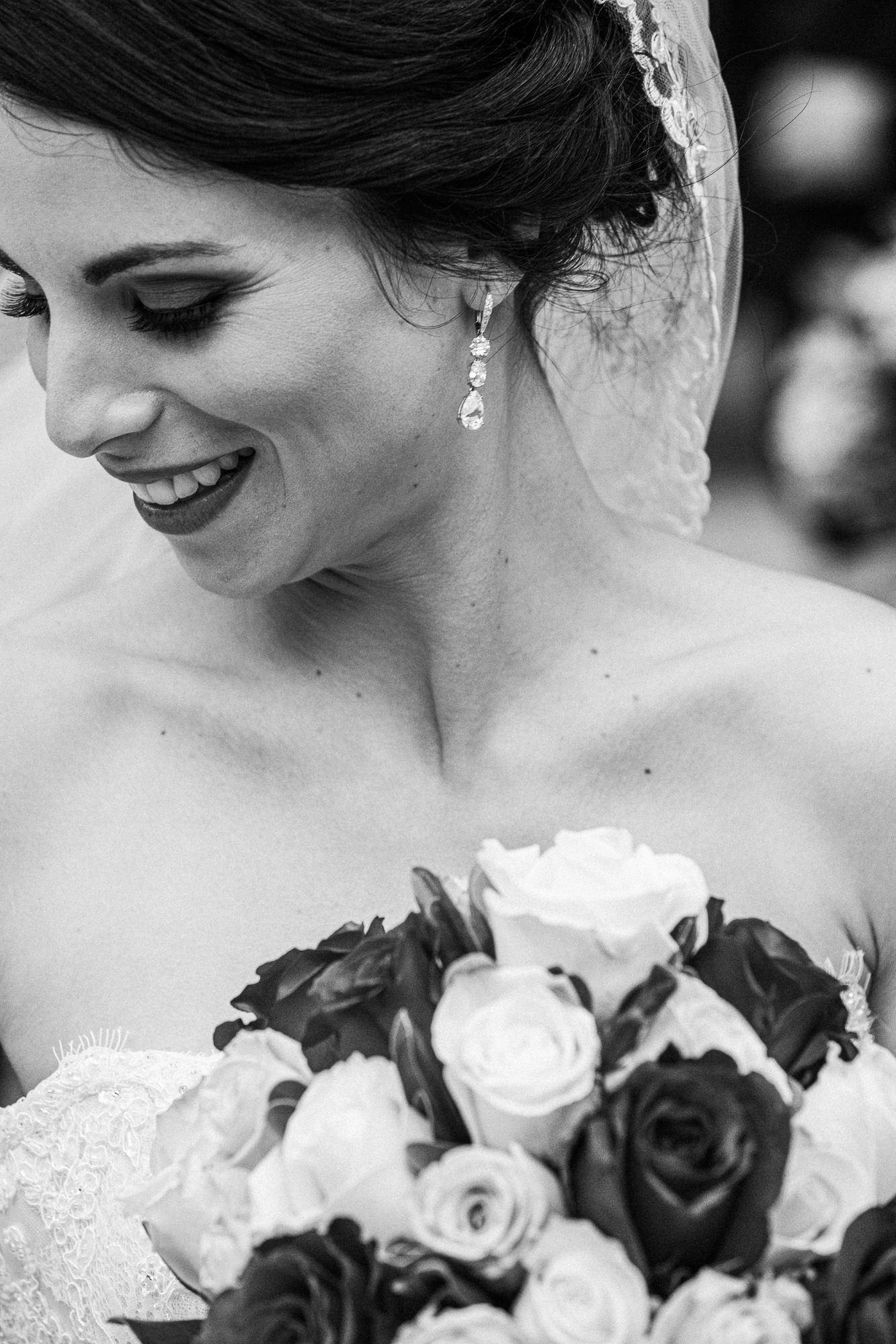 Black and white bridal portraits with classic roses bouquet and elegant lace details.