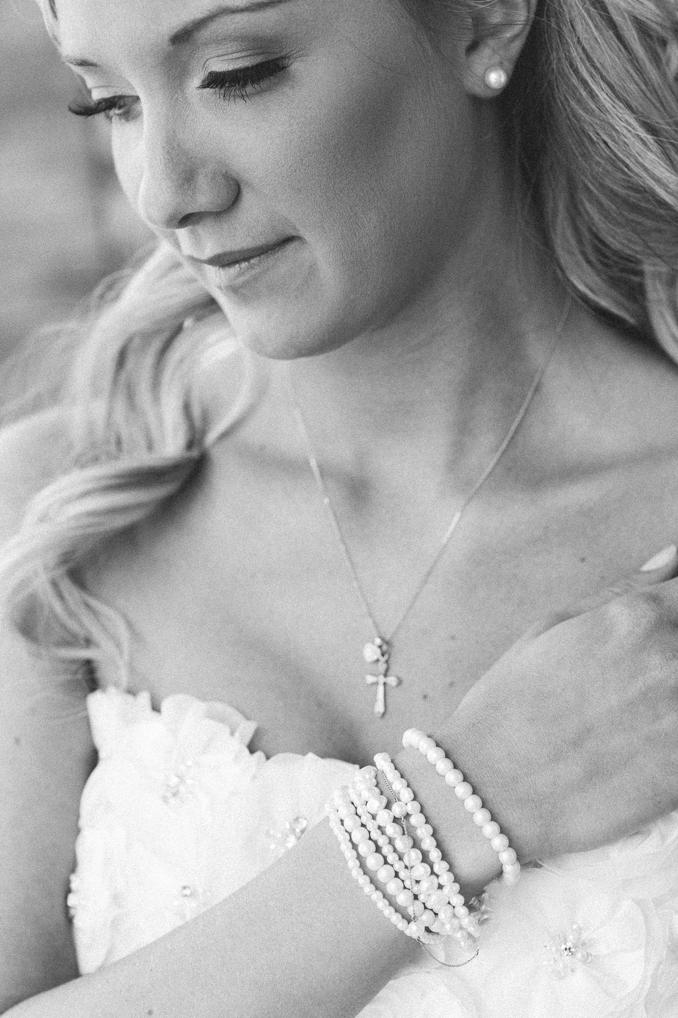 Black and white portrait series showing delicate bridal jewelry and dress details.