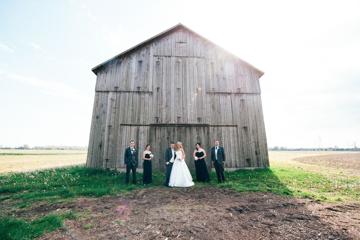 Rustic barn wedding venue photographed in a panoramic series across a rural landscape.