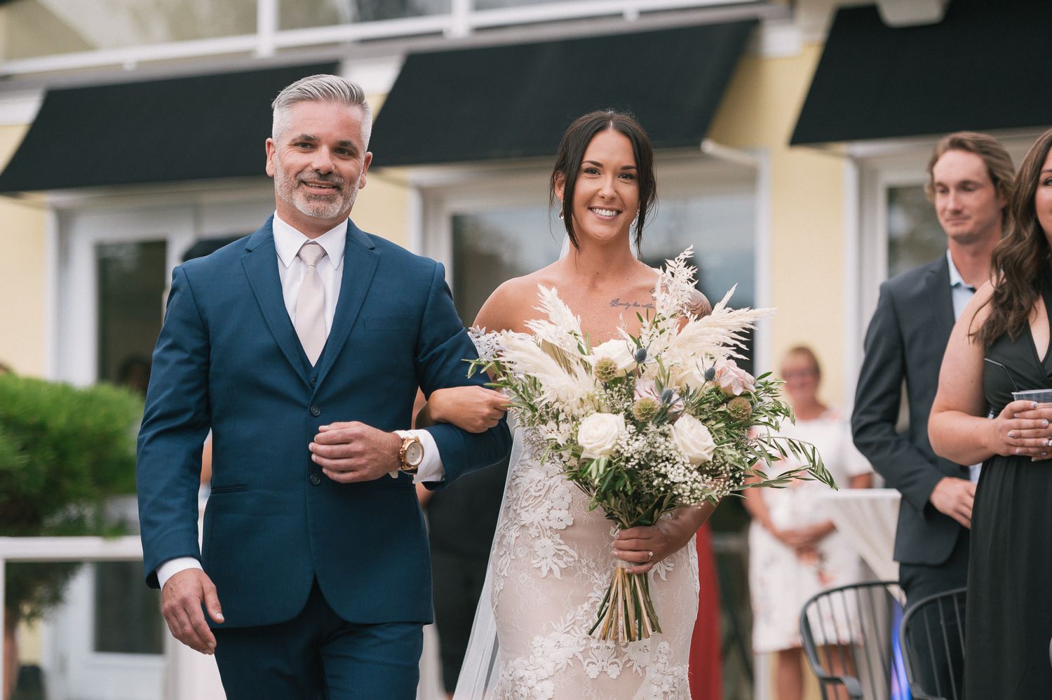 Candid wedding reception moments with guests celebrating outdoors.
