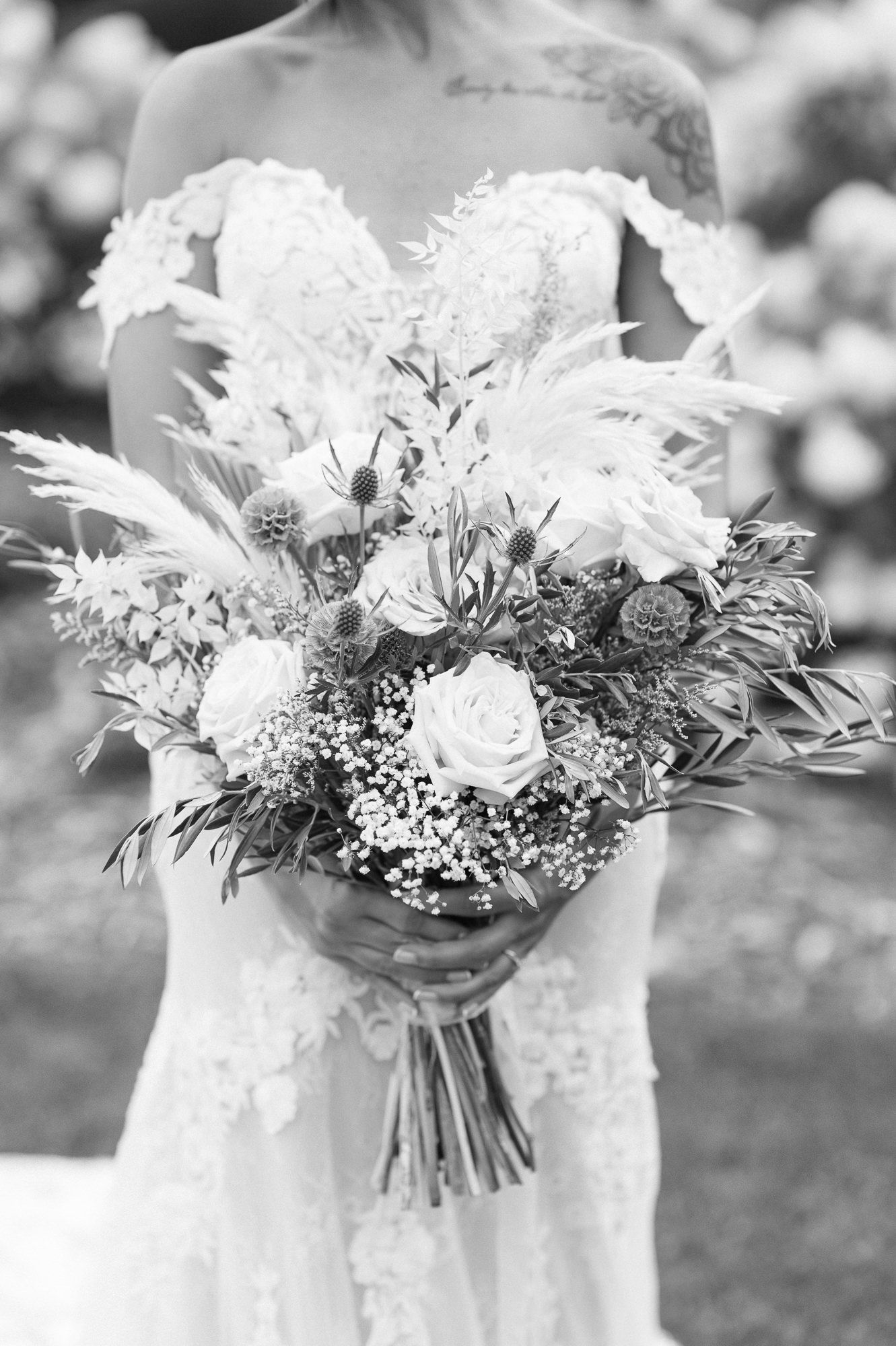 Elegant white and green wedding bouquets with roses and baby's breath in black and white.