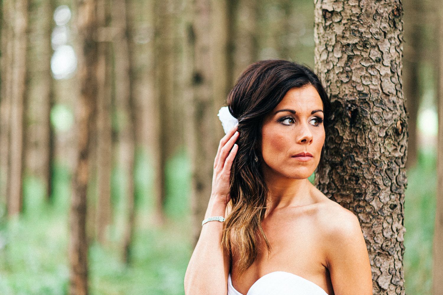 Elegant bridal portraits against a backdrop of pine trees.