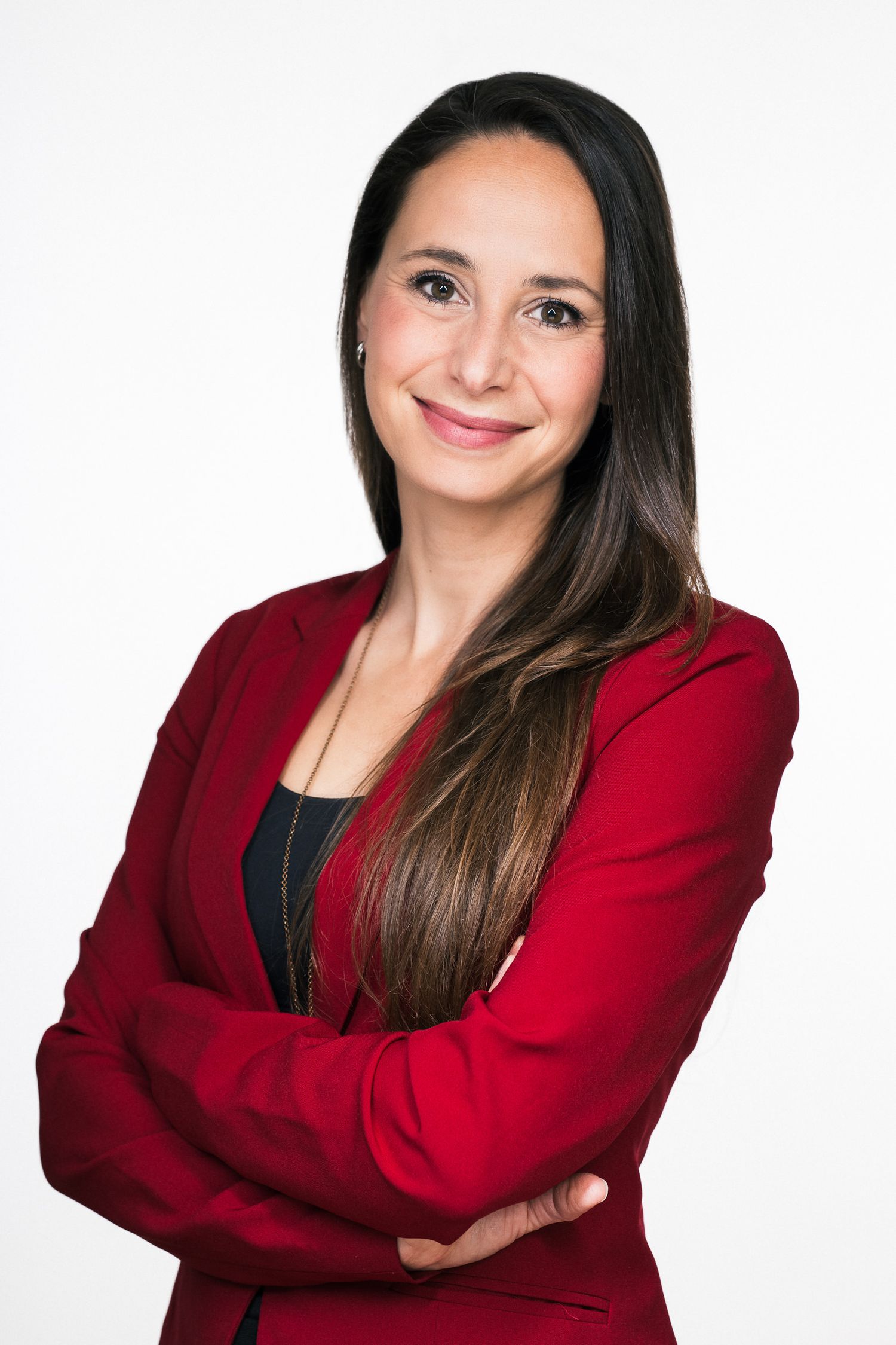 Professional woman in red blazer posing against white background in studio portraits.