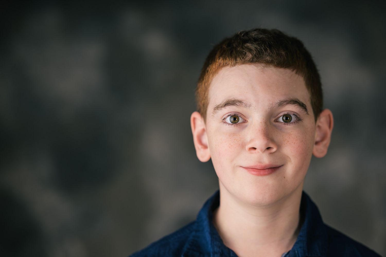 Series of expressive portraits against dark background showing different angles.