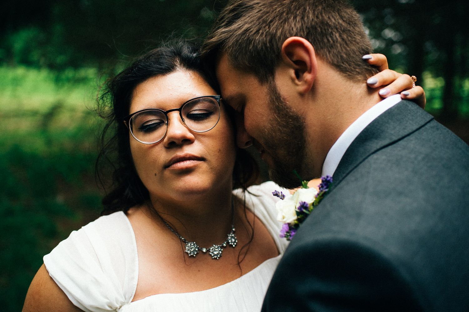 Intimate moment captured between couple during outdoor wedding celebration.