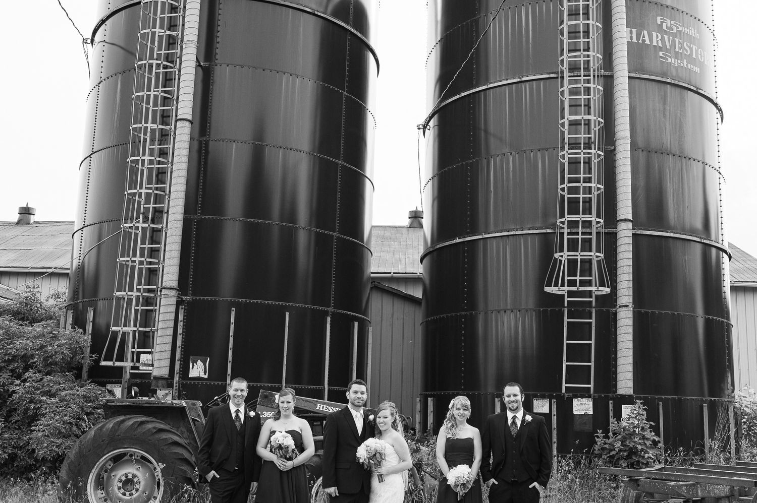 Row of large industrial storage tanks photographed in sequence.