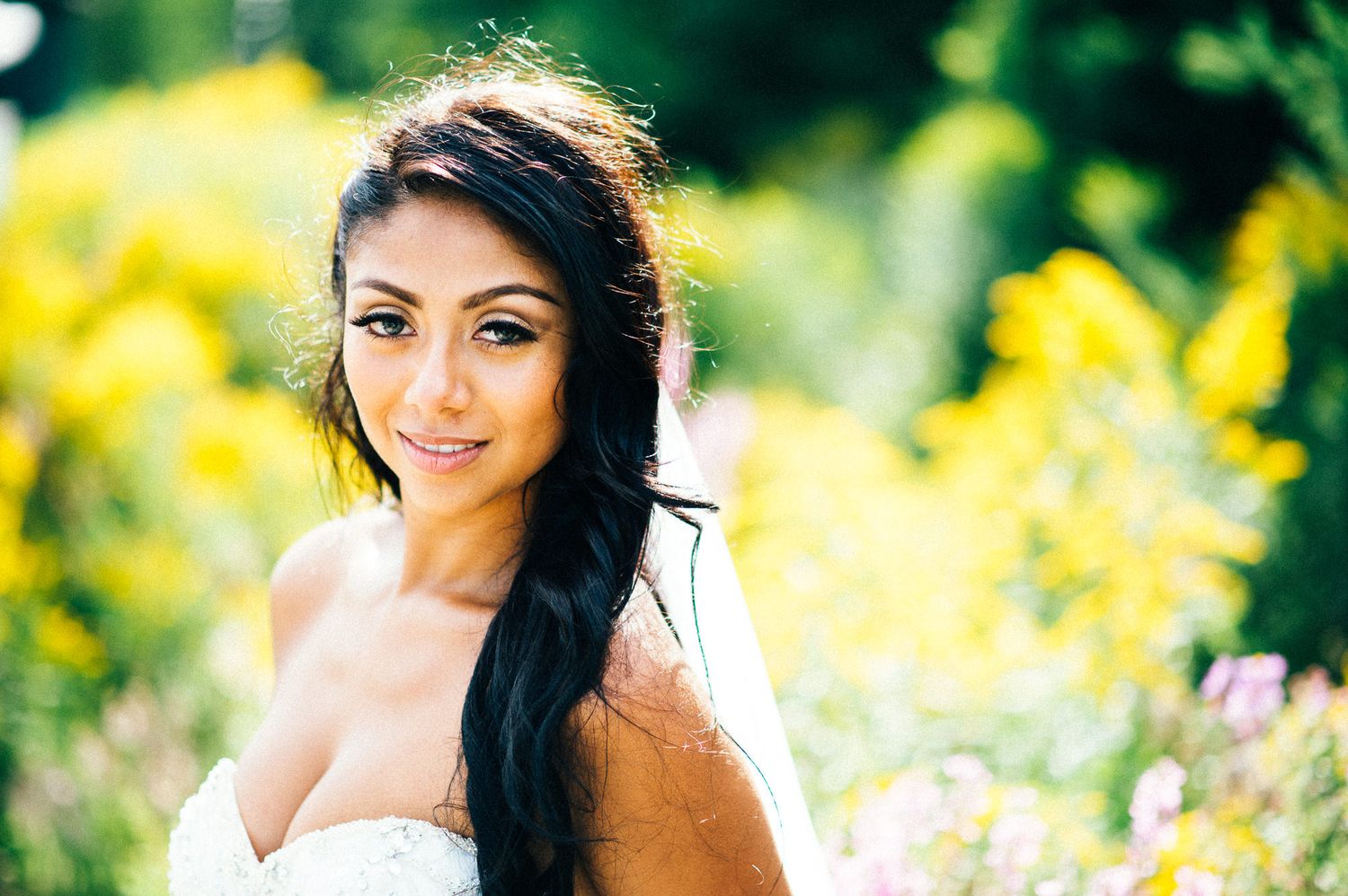 Portrait in a field of yellow wildflowers on a sunny summer day.
