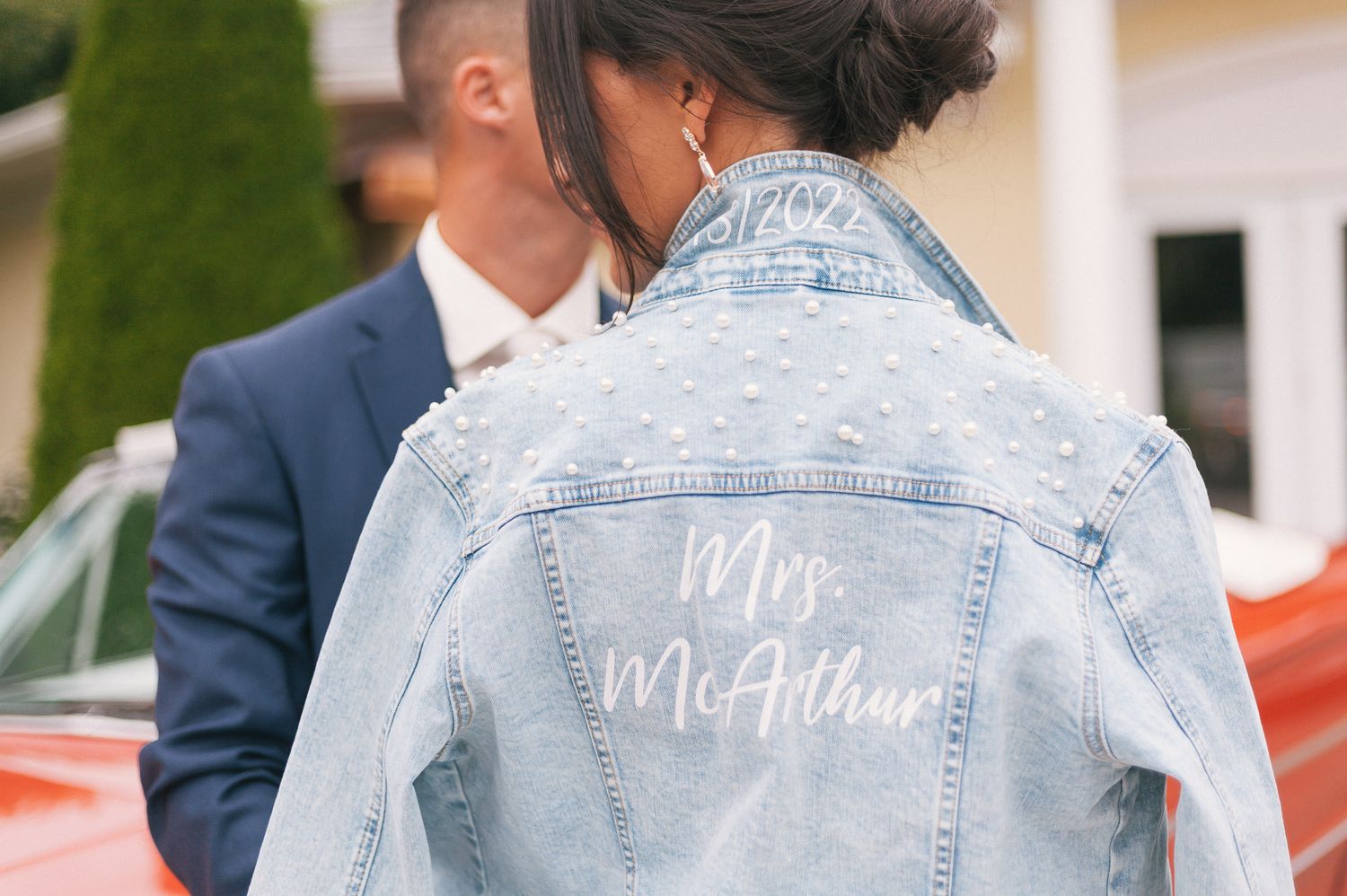 A custom denim jacket with 'McAdam' written in white script lettering.