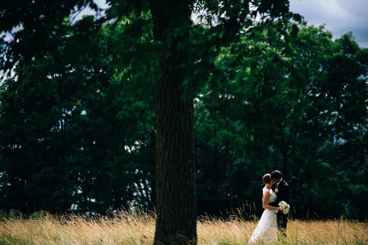 Natural outdoor wedding ceremony setup with chairs arranged in wooded setting.