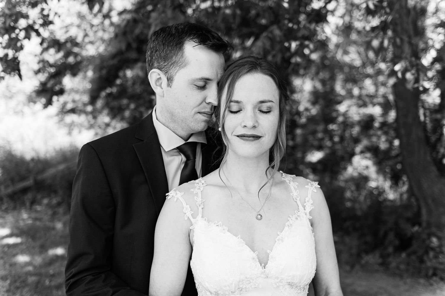 Intimate black and white wedding portrait showing tender moments between the couple.