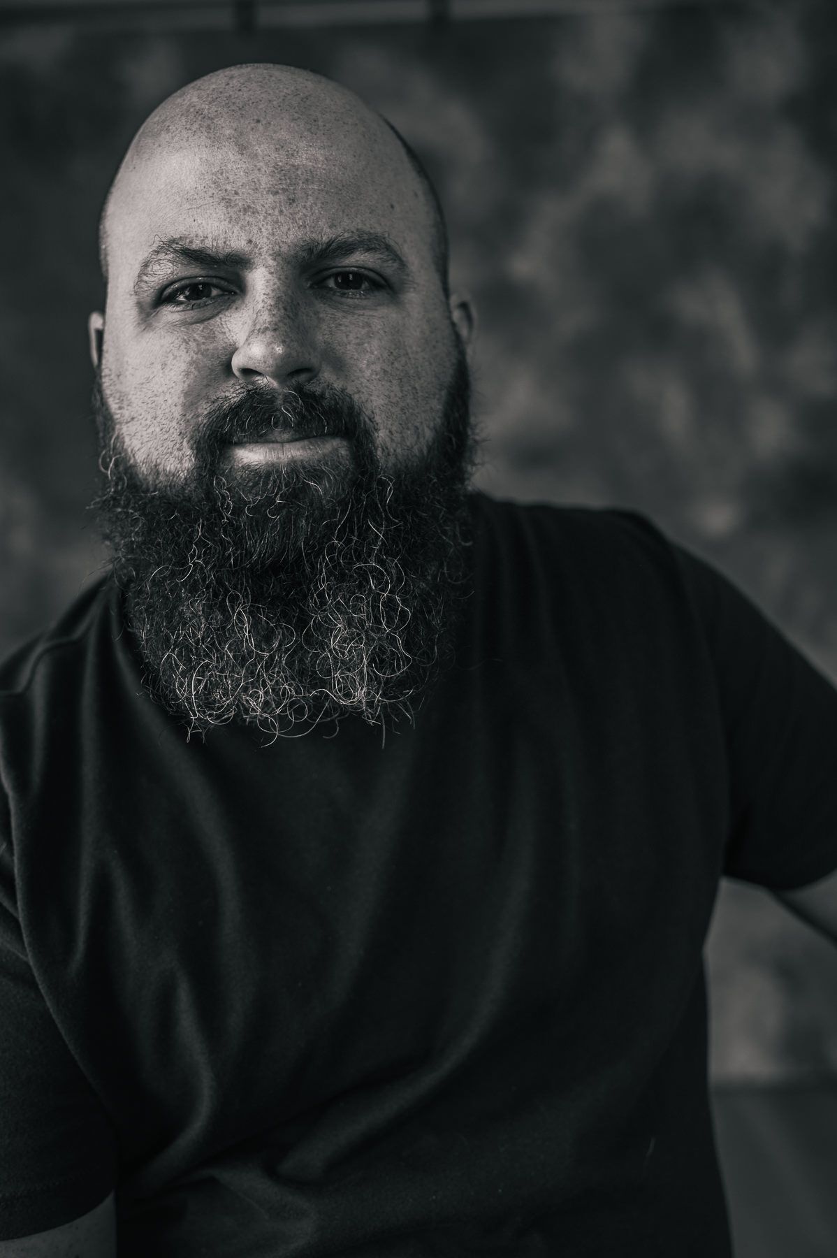 Black and white portrait series showing close-up expressions in dramatic lighting.