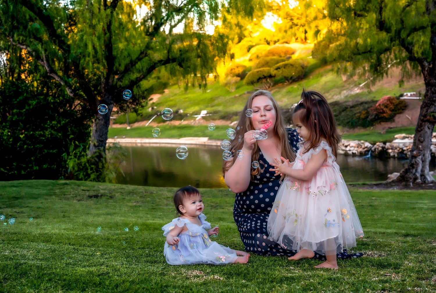 A group enjoys a picturesque outdoor photo session in a lush green park during golden hour.