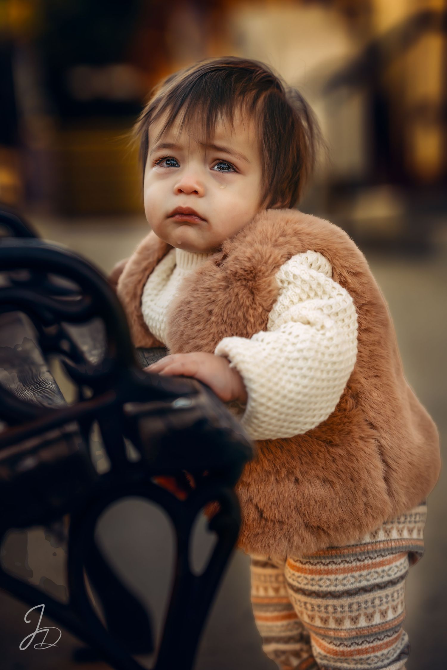 Cozy winter outfit with brown fur vest and knit sweater details.