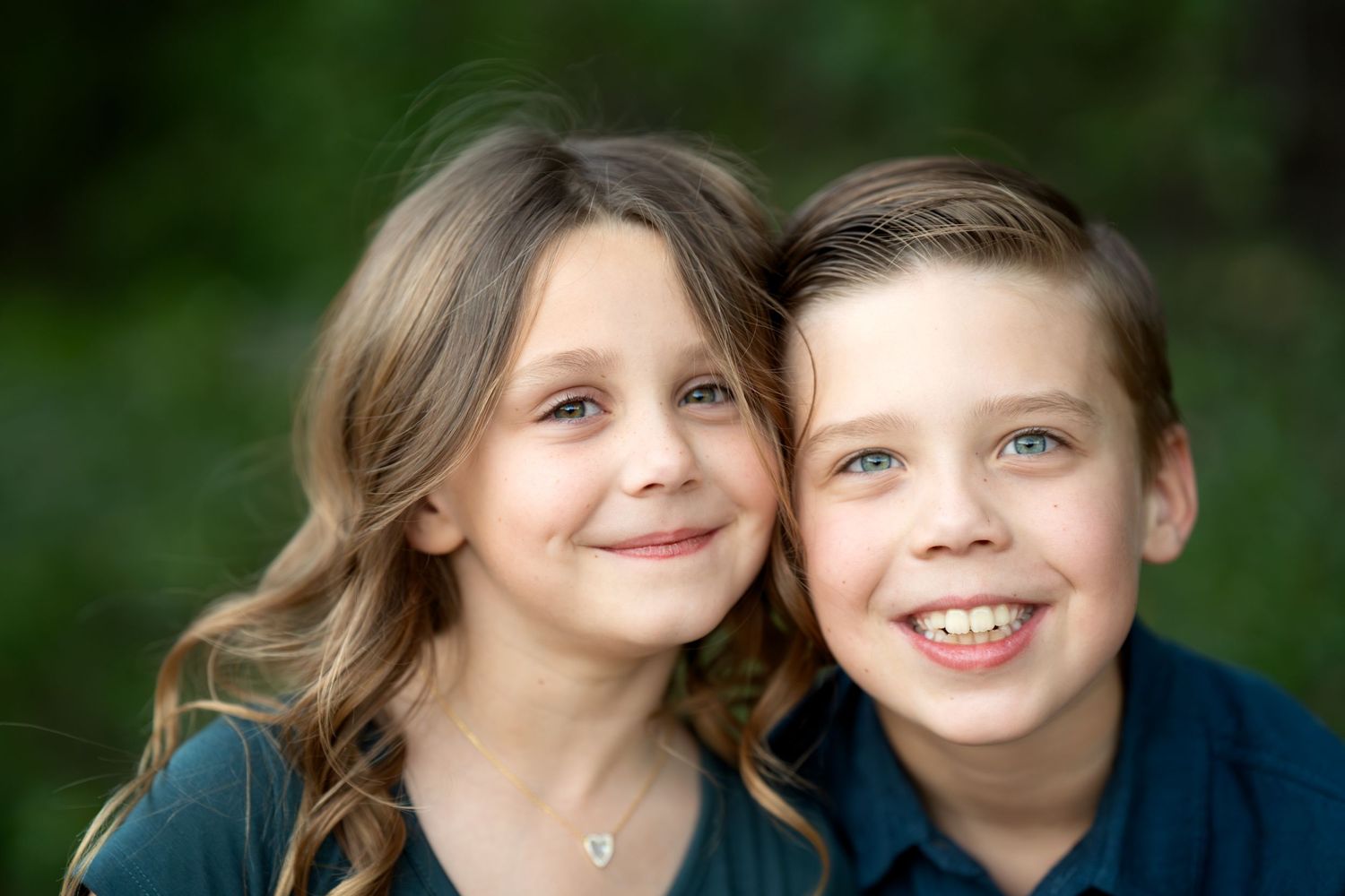 Sweet candid moments captured in an outdoor portrait session with natural lighting.