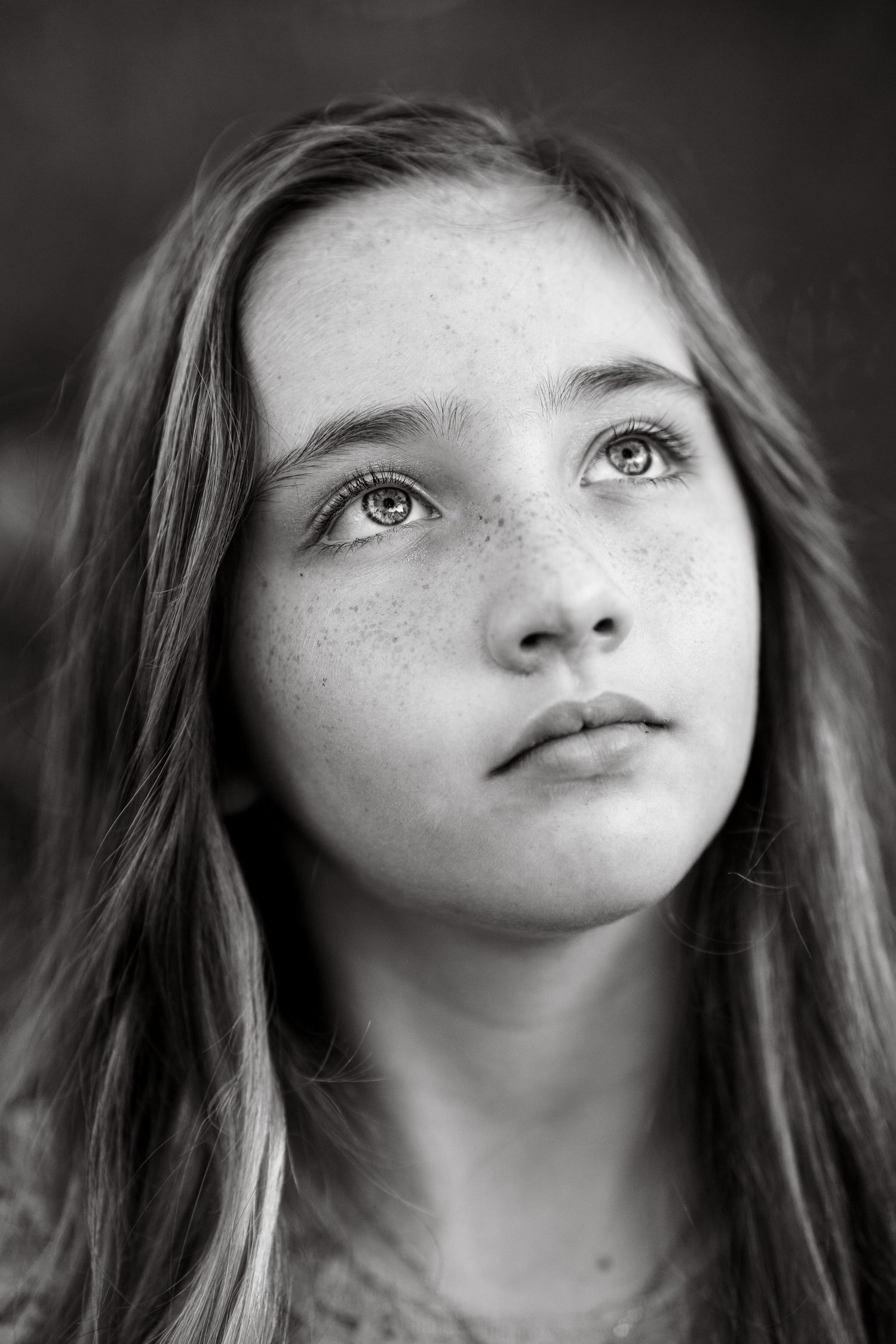 A series of artistic black and white close-up portrait shots with dramatic lighting.