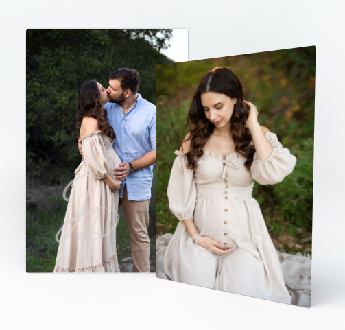 Romantic maternity photoshoot in cream dress against natural backdrop.