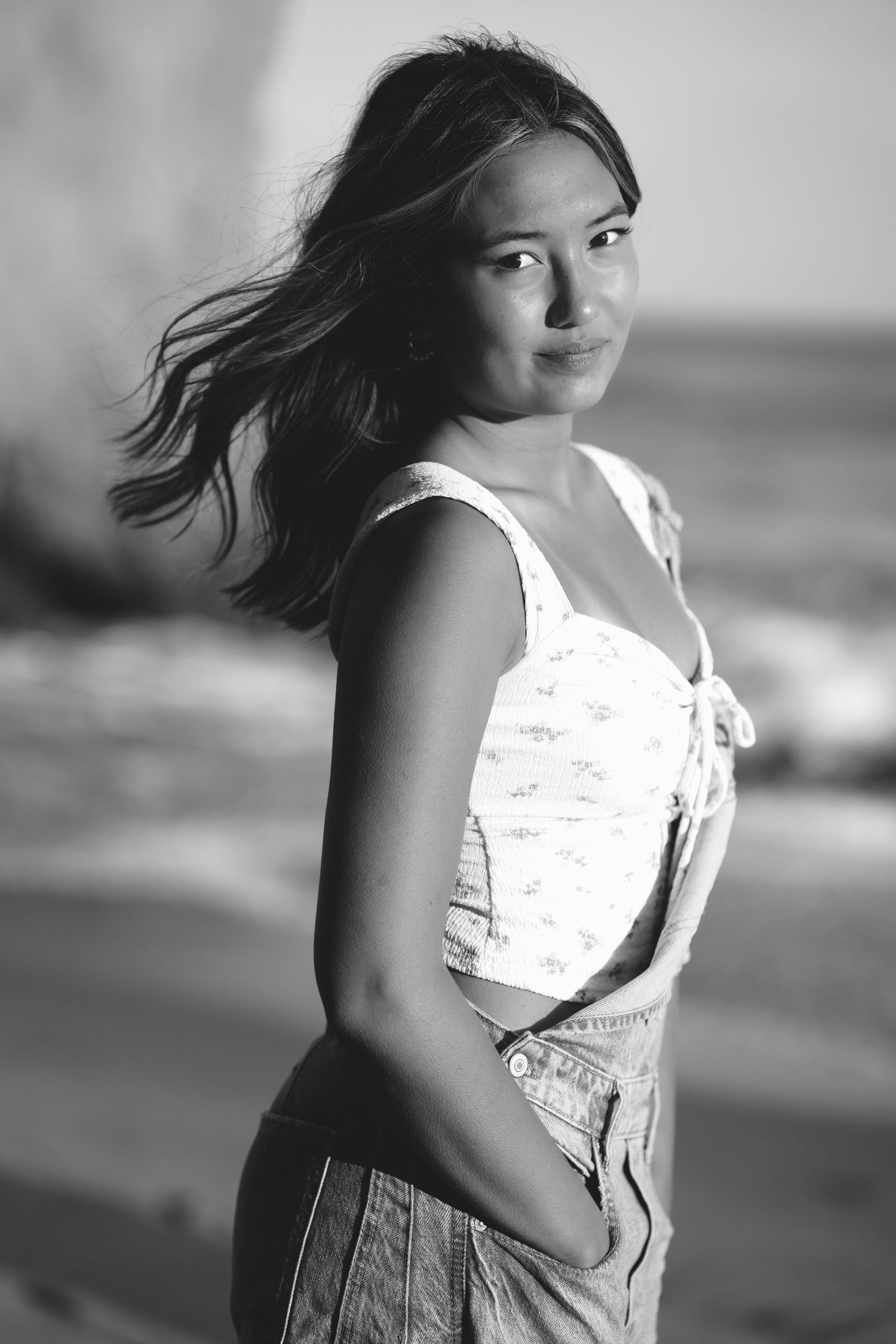 Black and white portraits with wind-blown hair against blurred background.
