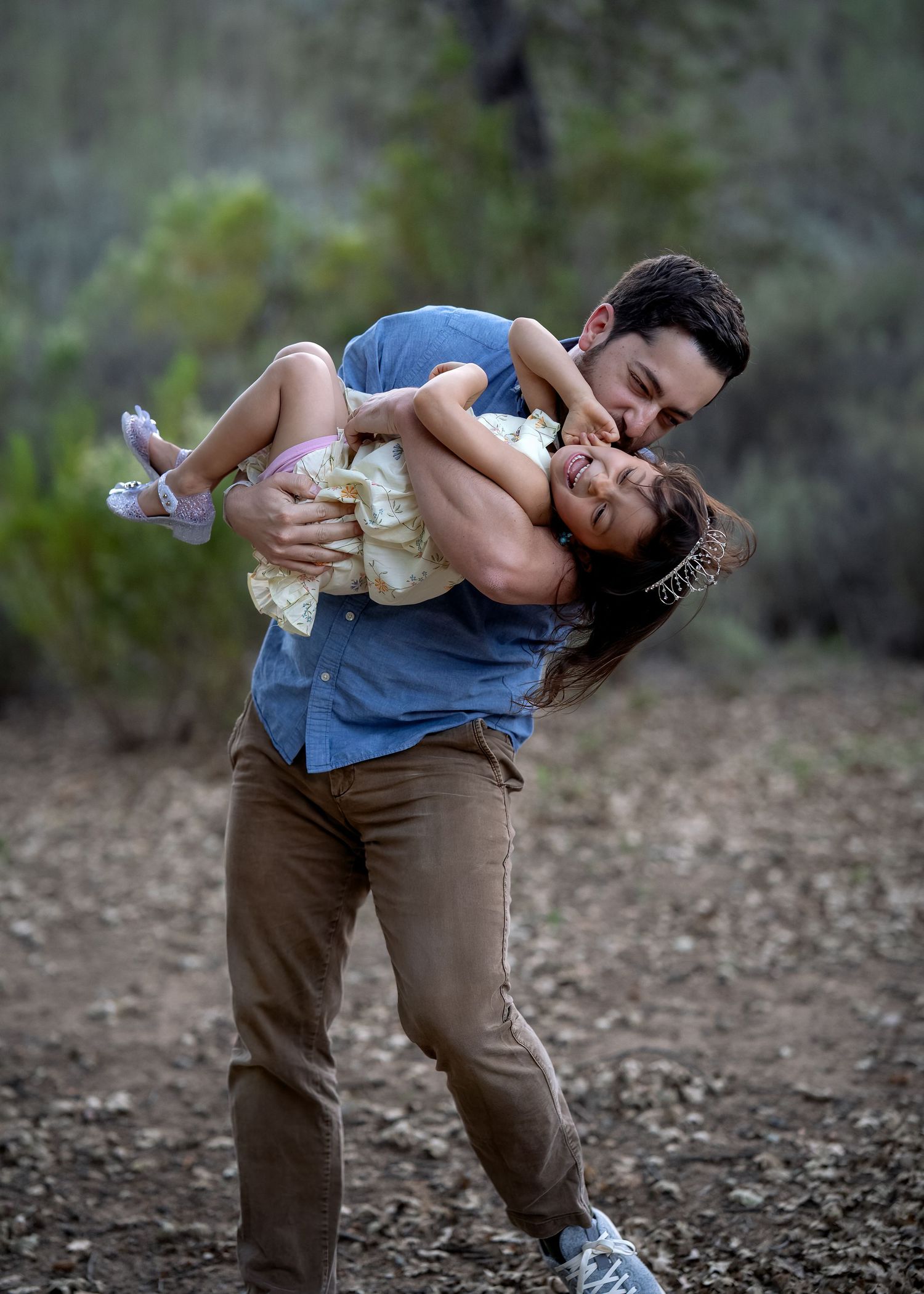 A couple shares a romantic dip pose during an outdoor photoshoot.