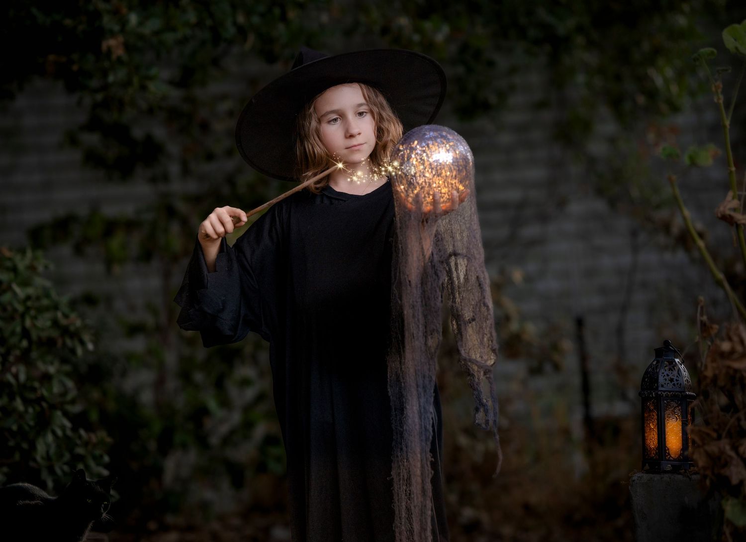 A magical scene shows a figure in black holding a glowing wand near an illuminated lantern.