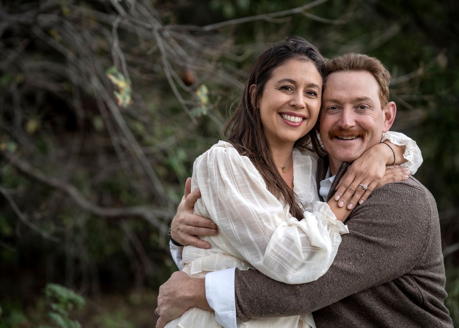 Intimate couple portraits captured against natural outdoor backdrop.