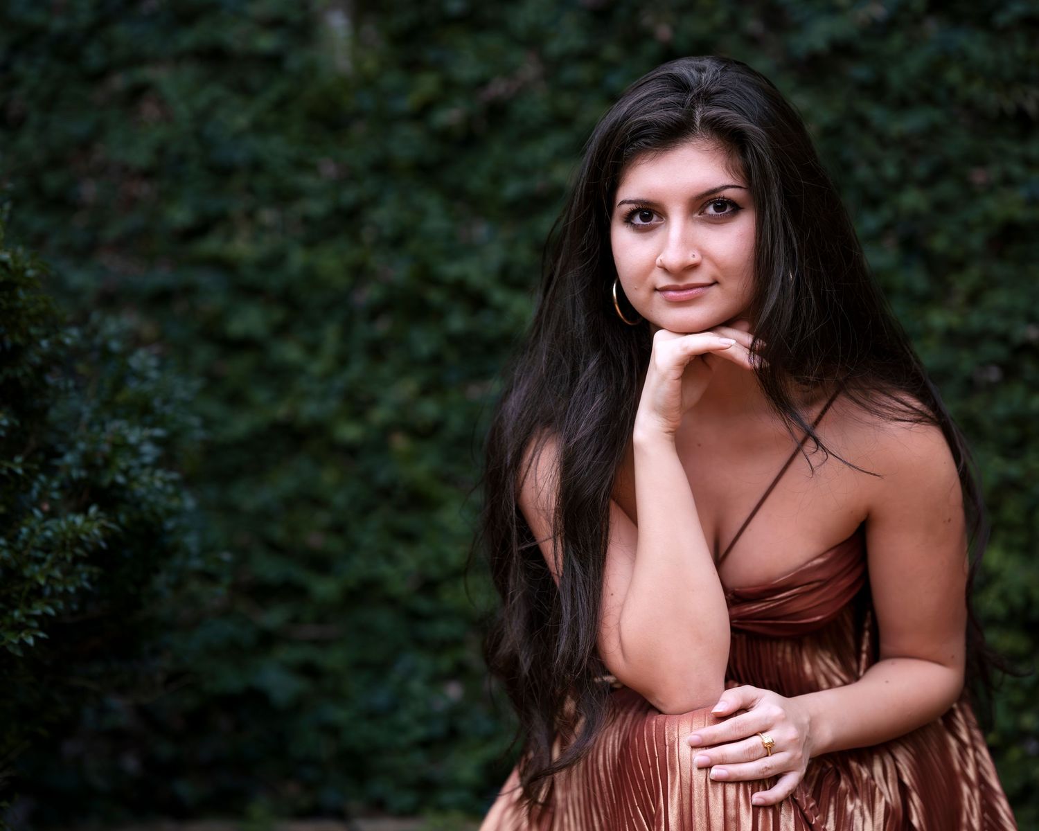 A series of eight similar portrait photos showing someone in a brown dress against a dark background.