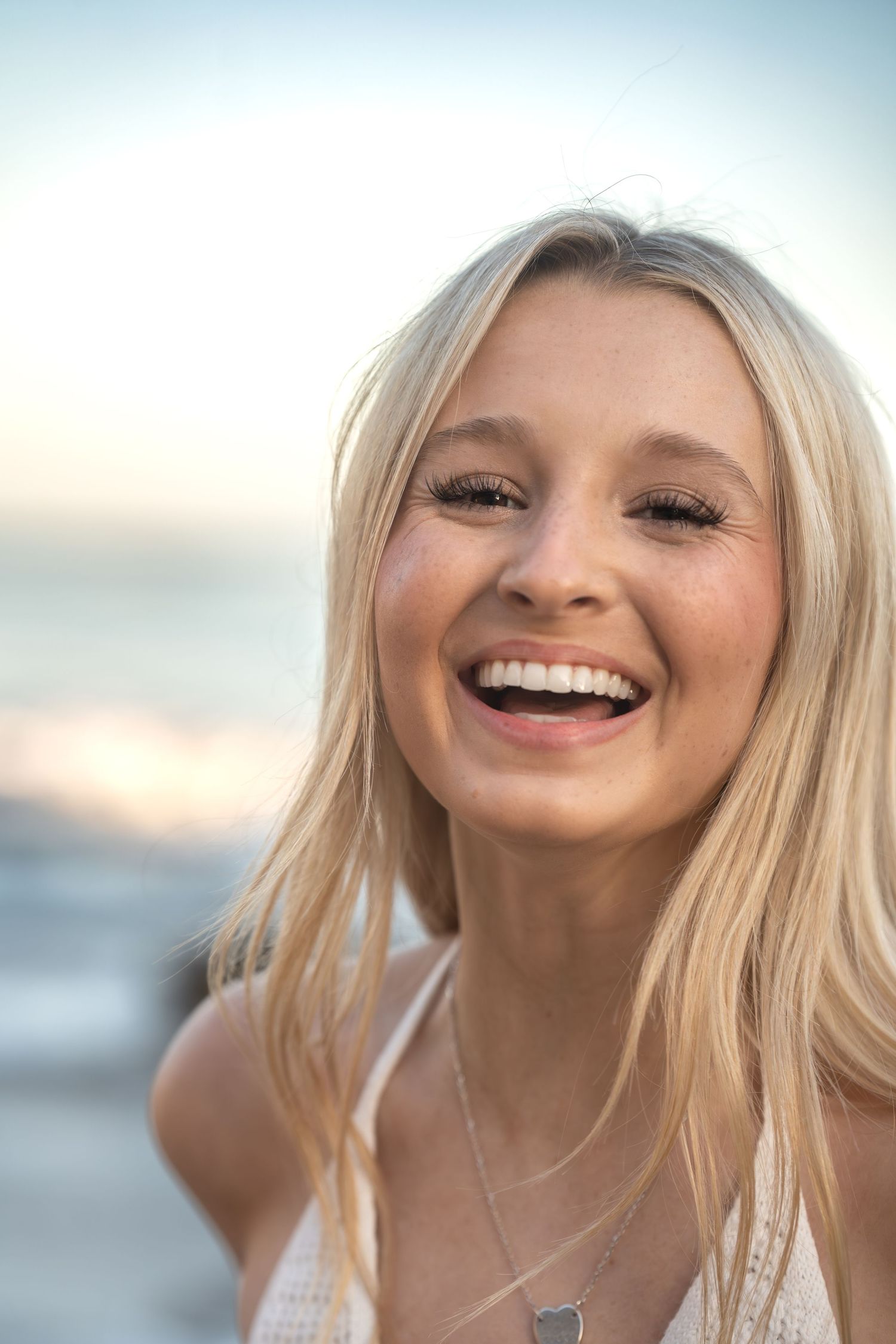 Close-up beach portrait with natural lighting and soft sunset colors.