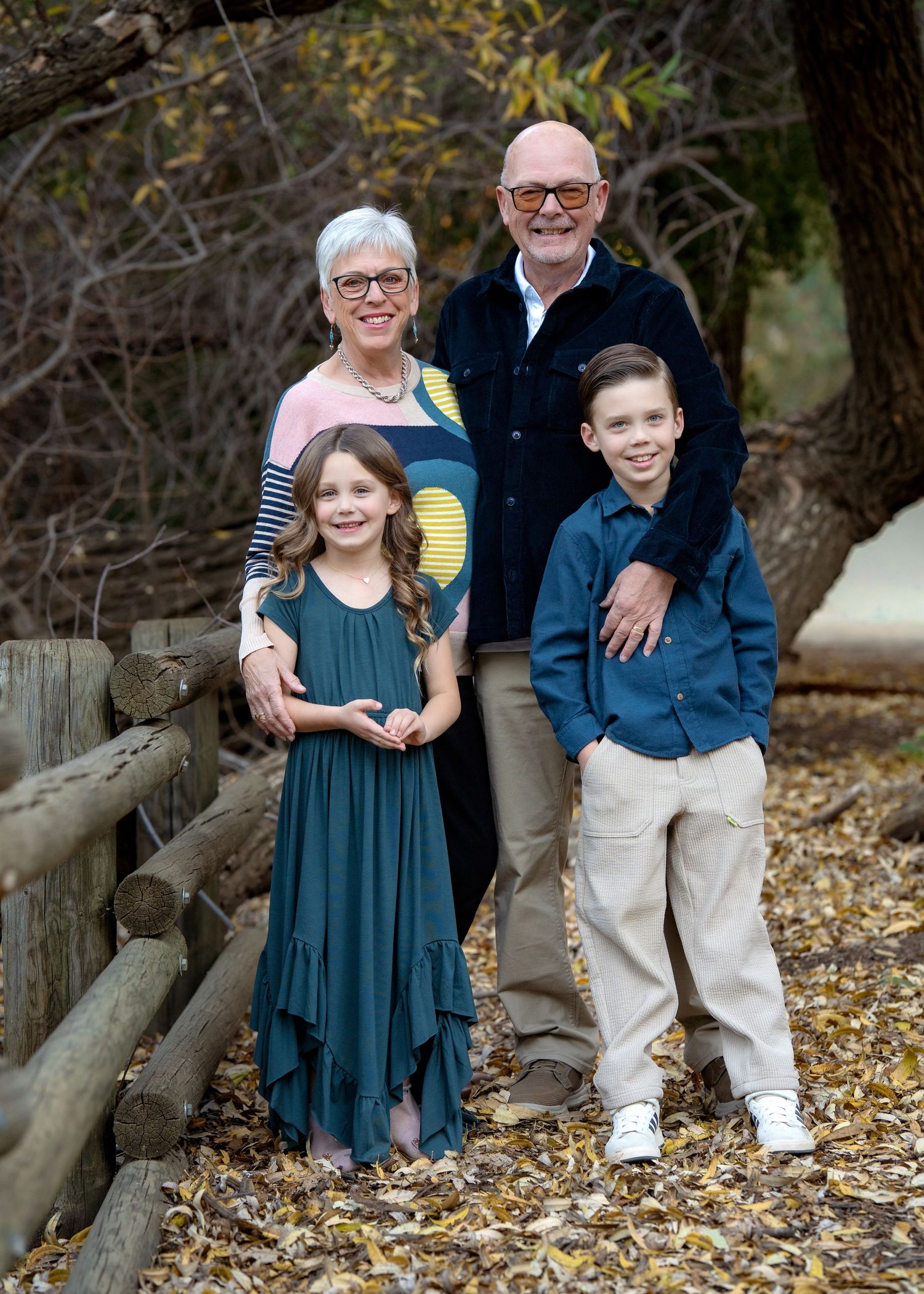 A series of five similar outdoor family portraits showing a young child in a blue dress with adults against a natural backdrop.