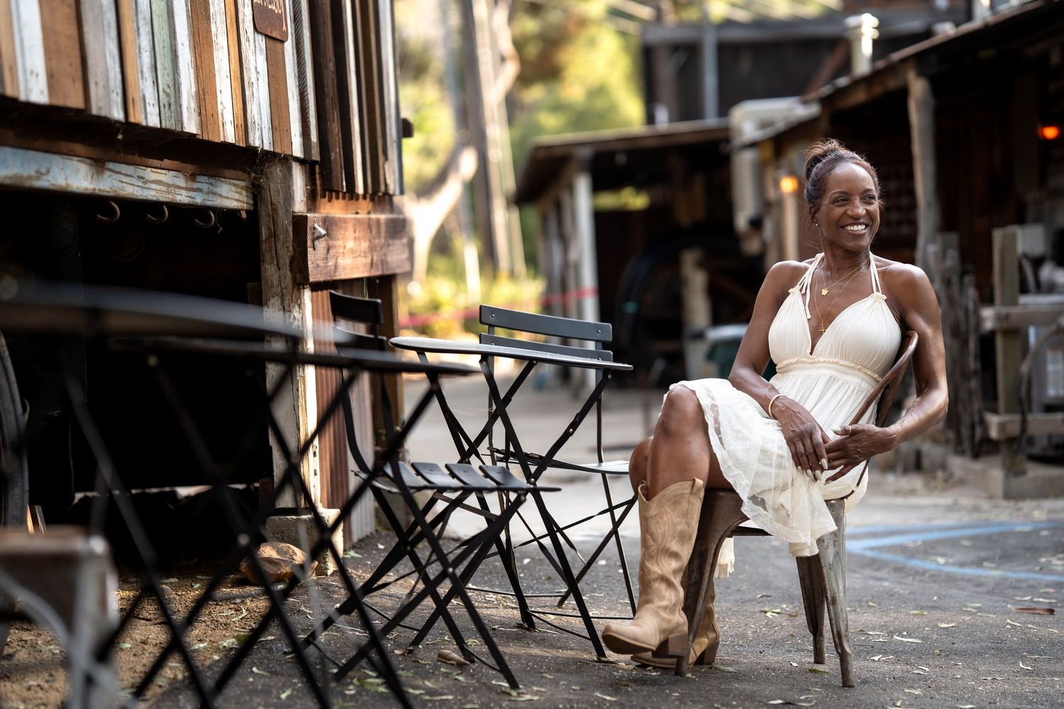 A light blue flowy dress is captured in a series of dynamic movement shots against a rustic wooden backdrop.
