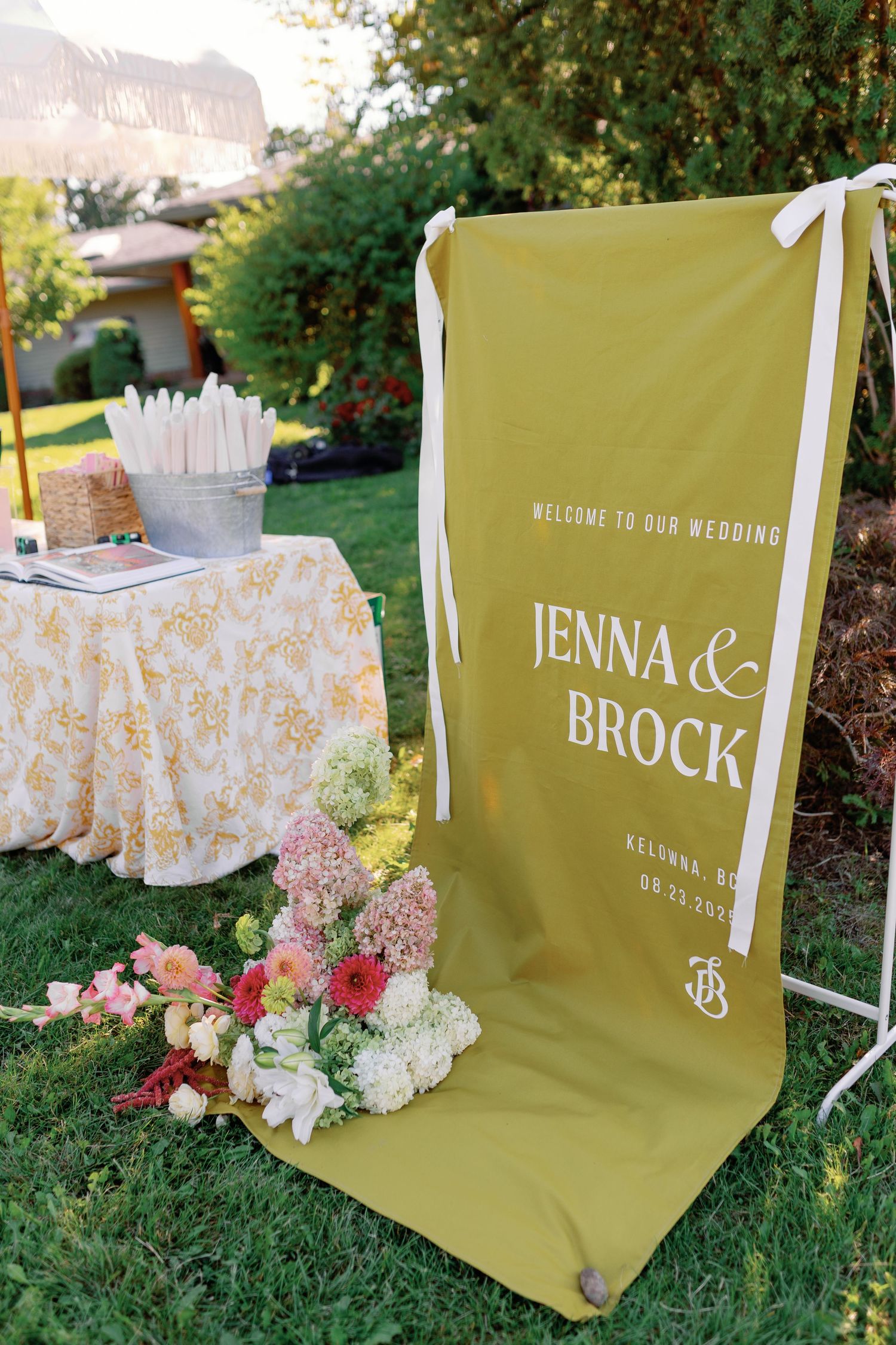 Gold wedding welcome sign for Jenna and Brock in Kelowna BC outdoor garden ceremony.