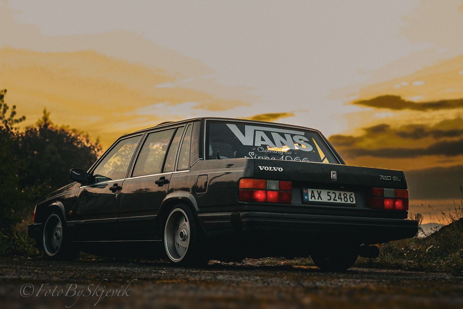 Classic black Volvo cars arranged artistically during golden hour photography session.